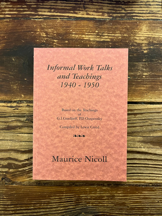 Pink book titled 'Informal Work Talks and Teachings 1940-1950' by Maurice Nicoll on a wooden surface
