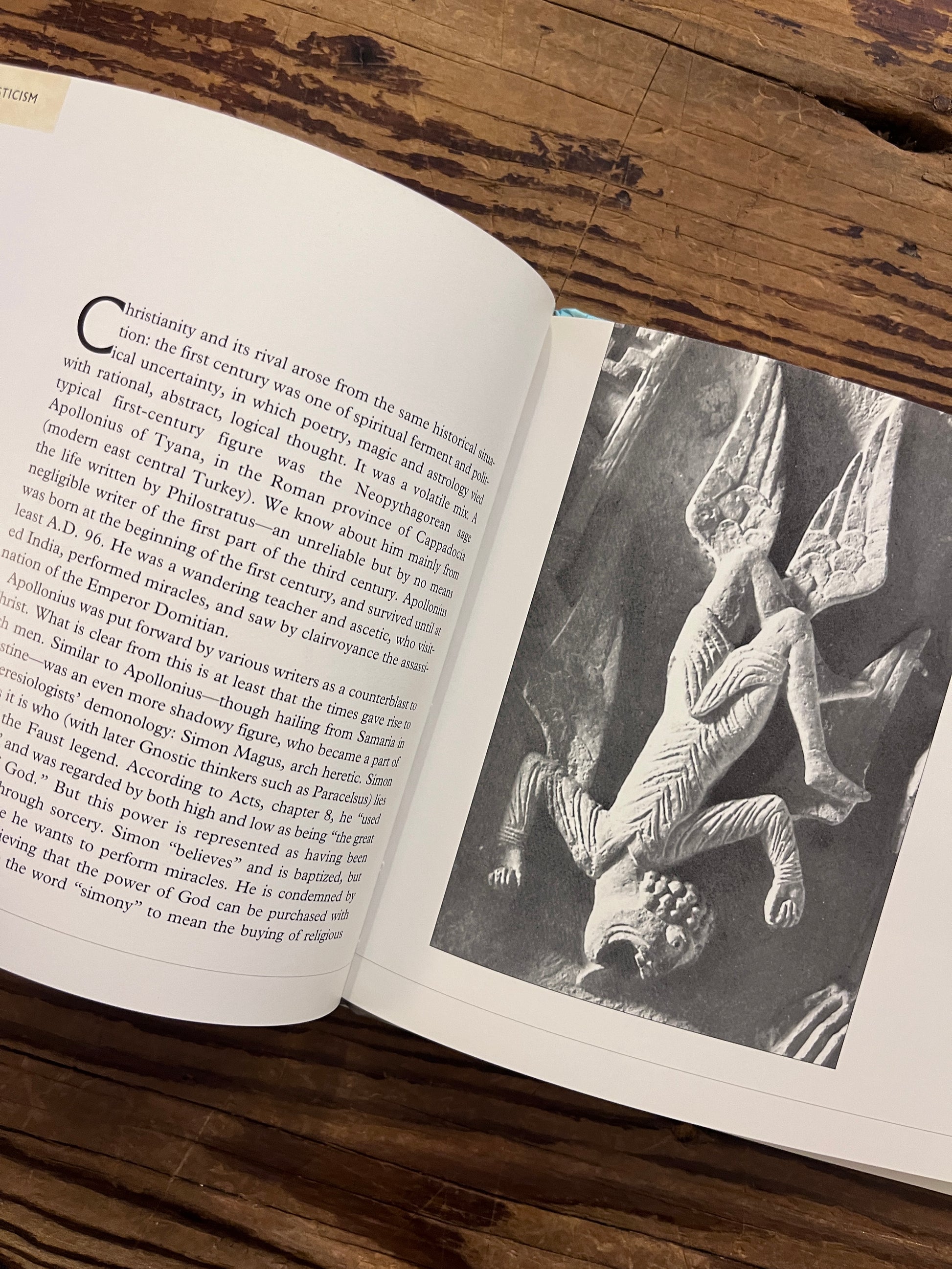 Open book titled 'Gnosticism: The Path of Inner Knowledge' by Martin Seymour-Smith on a wooden surface 
