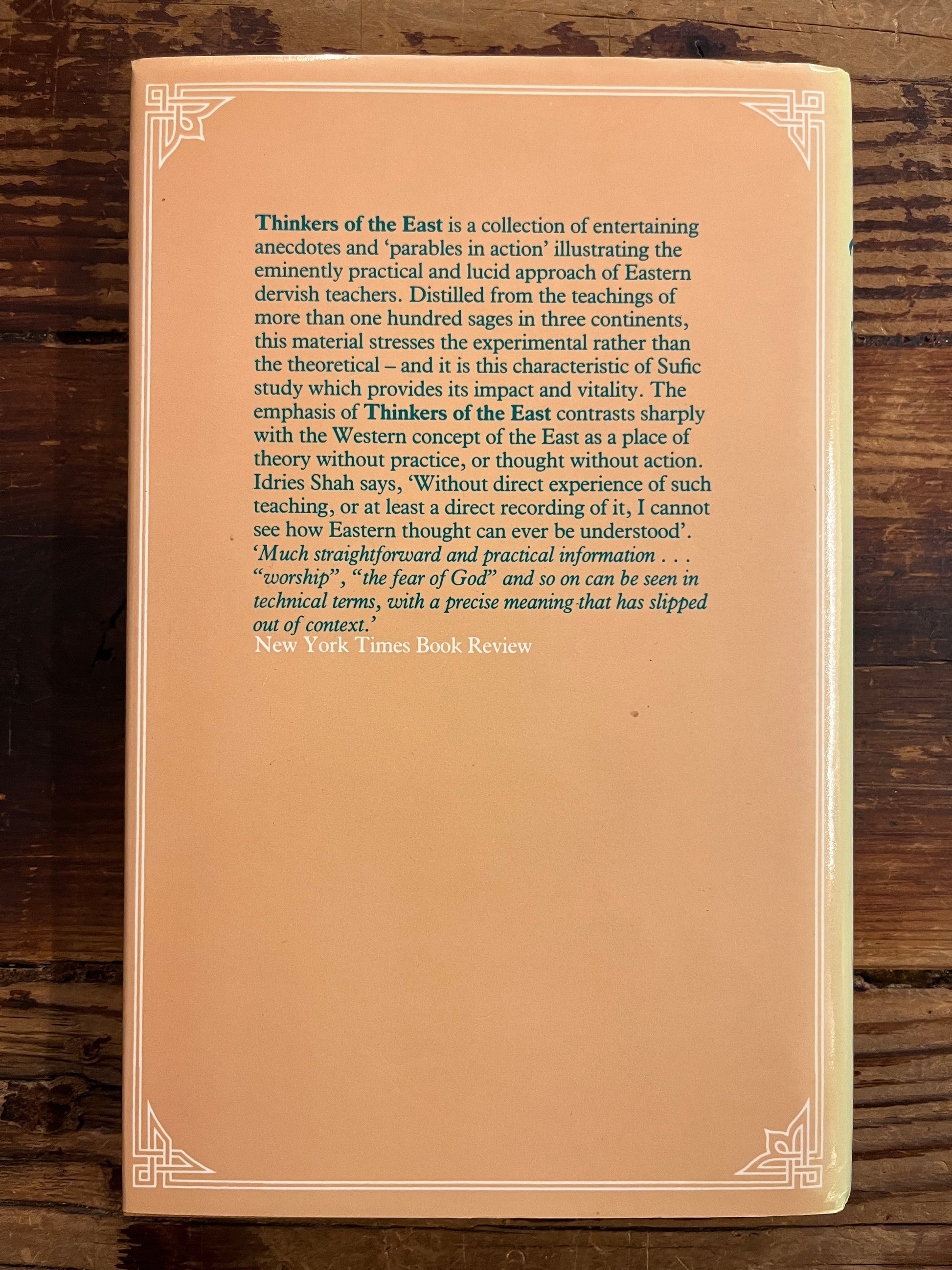 back cover of book titled 'Thinkers of the East' by Idries Shah on a wooden surface
