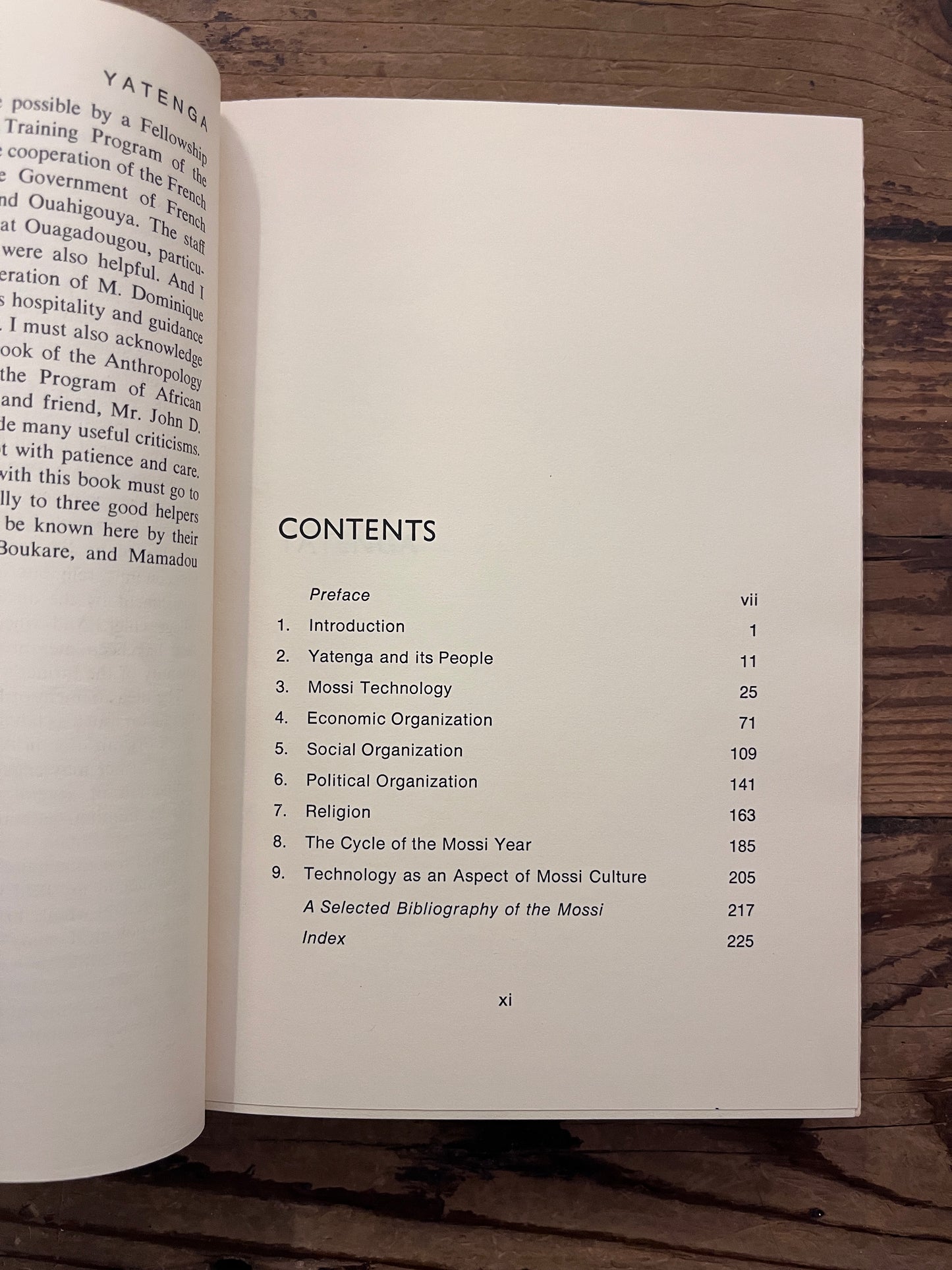 Contents of book titled 'Yatenga' by Peter B. Hammond on a wooden surface 