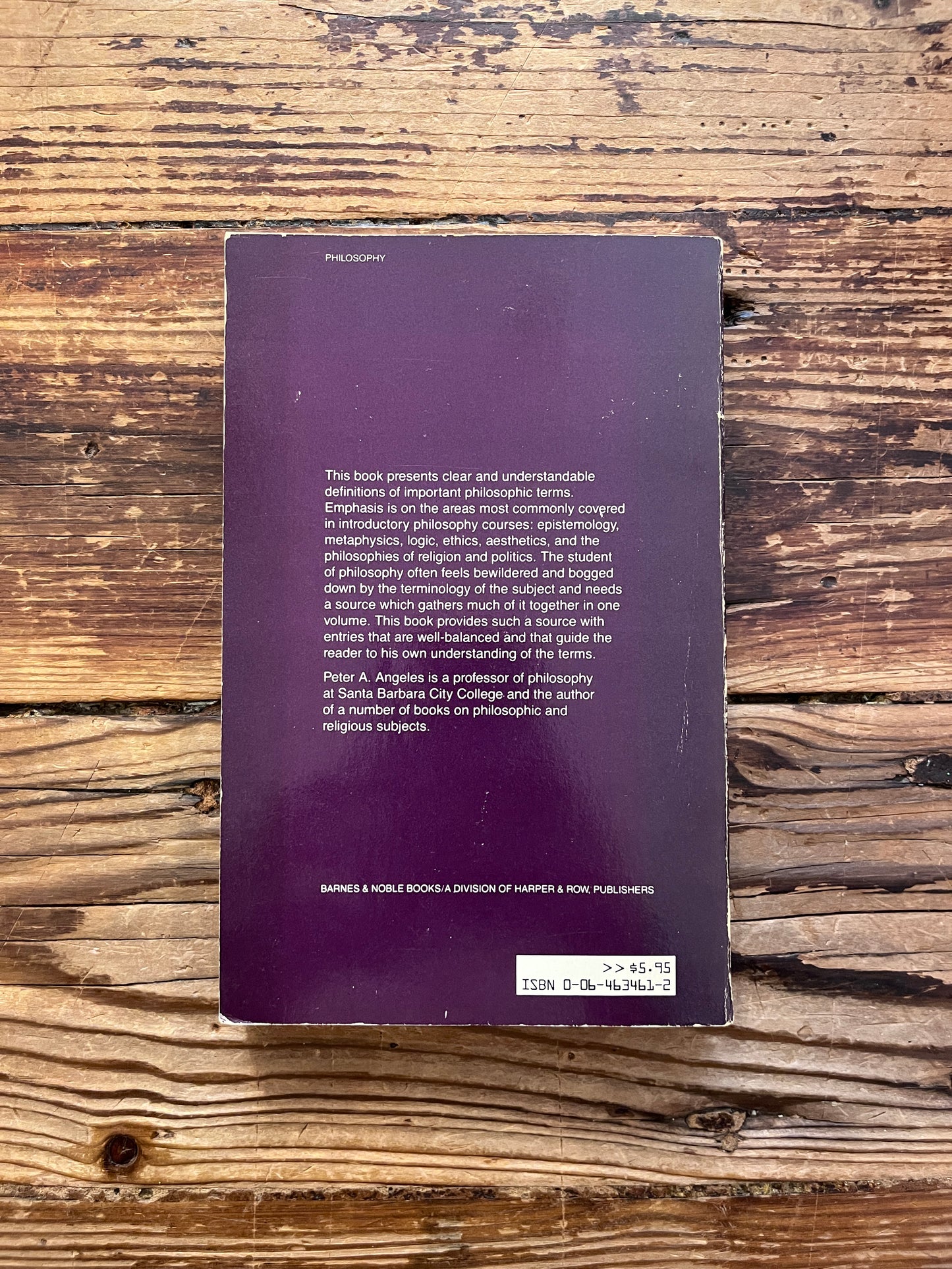 photo of the backcover of the book "Dictionary of philosophy" on a wooden background
