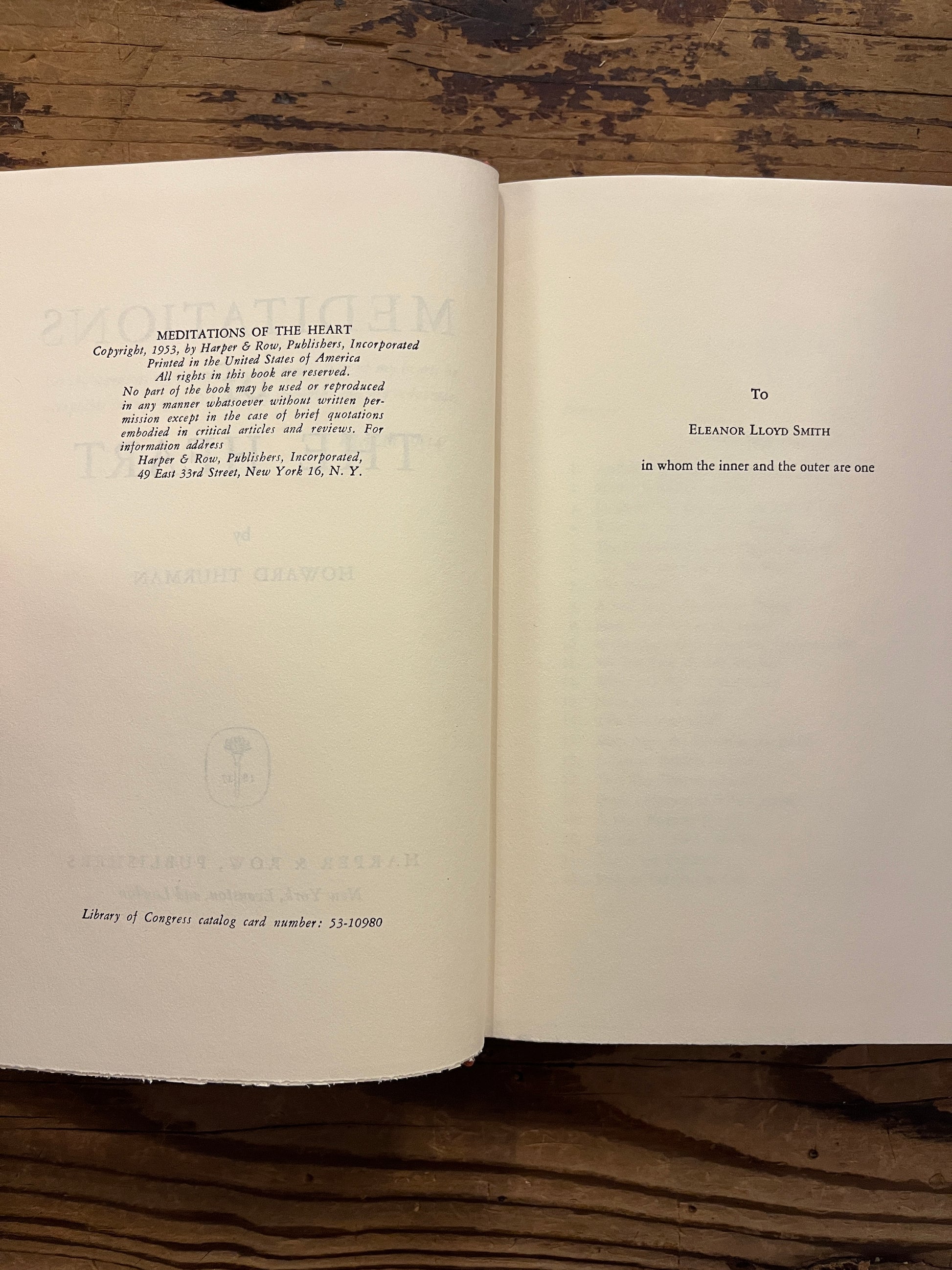 Open book titled 'Meditations of the Heart' by Howard Thurman on a wooden surface