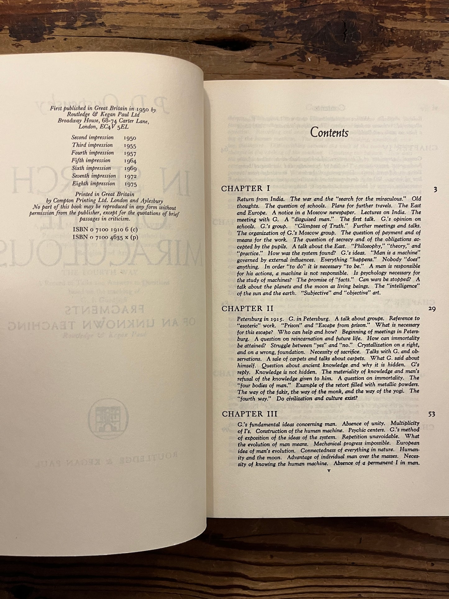 Open book titled 'In Search of the Miraculous' by P.D. Ouspensky on a wooden surface