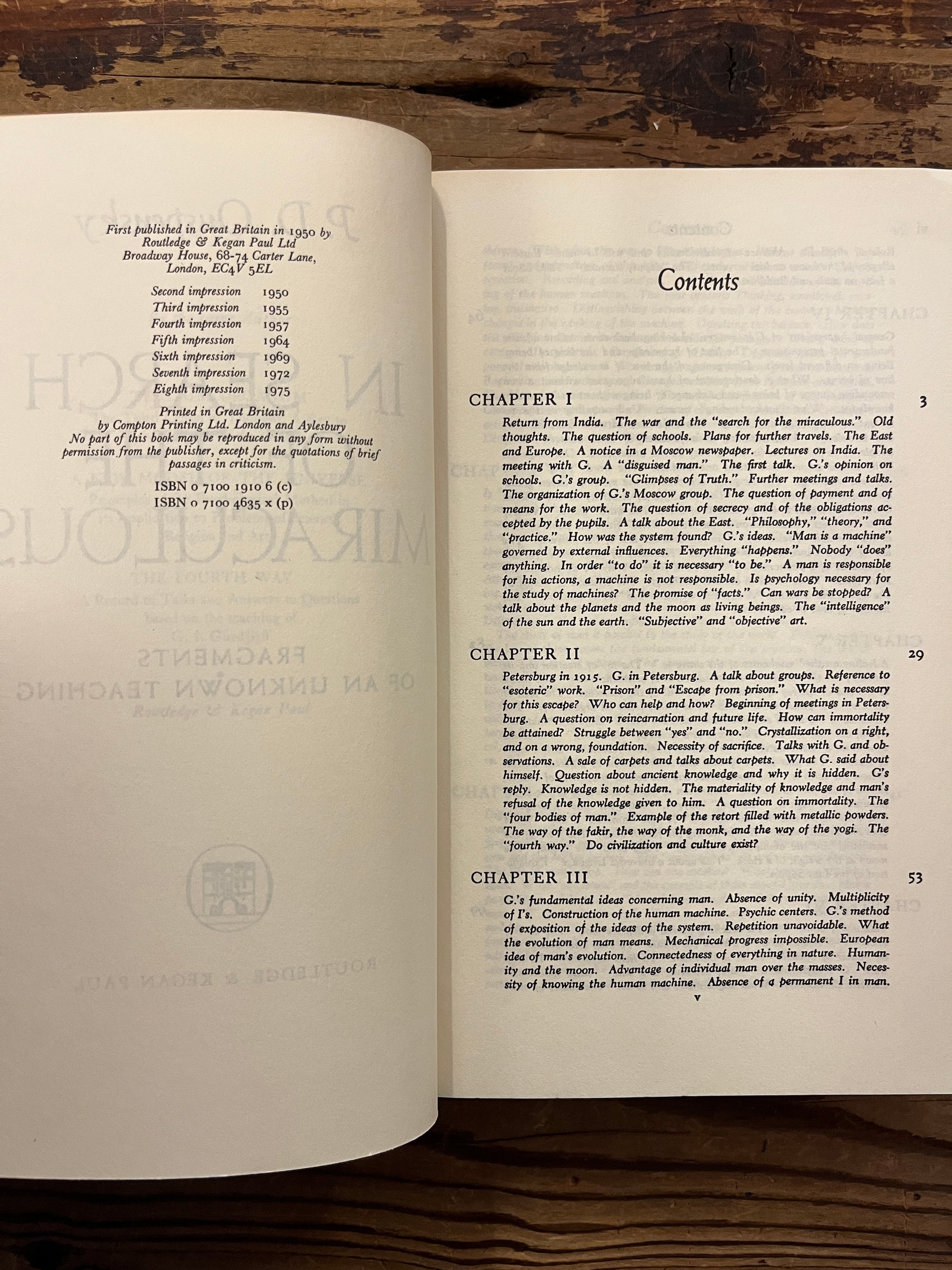 Open book titled 'In Search of the Miraculous' by P.D. Ouspensky on a wooden surface