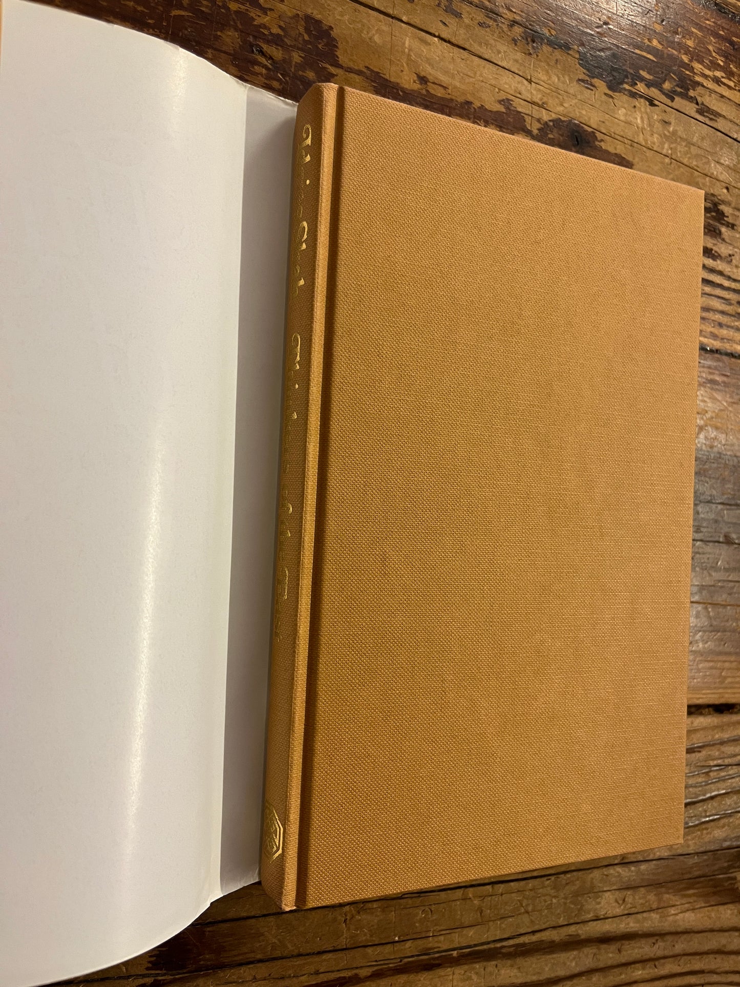 Brown cloth book titled 'Thinkers of the East' by Idries Shah on a wooden surface