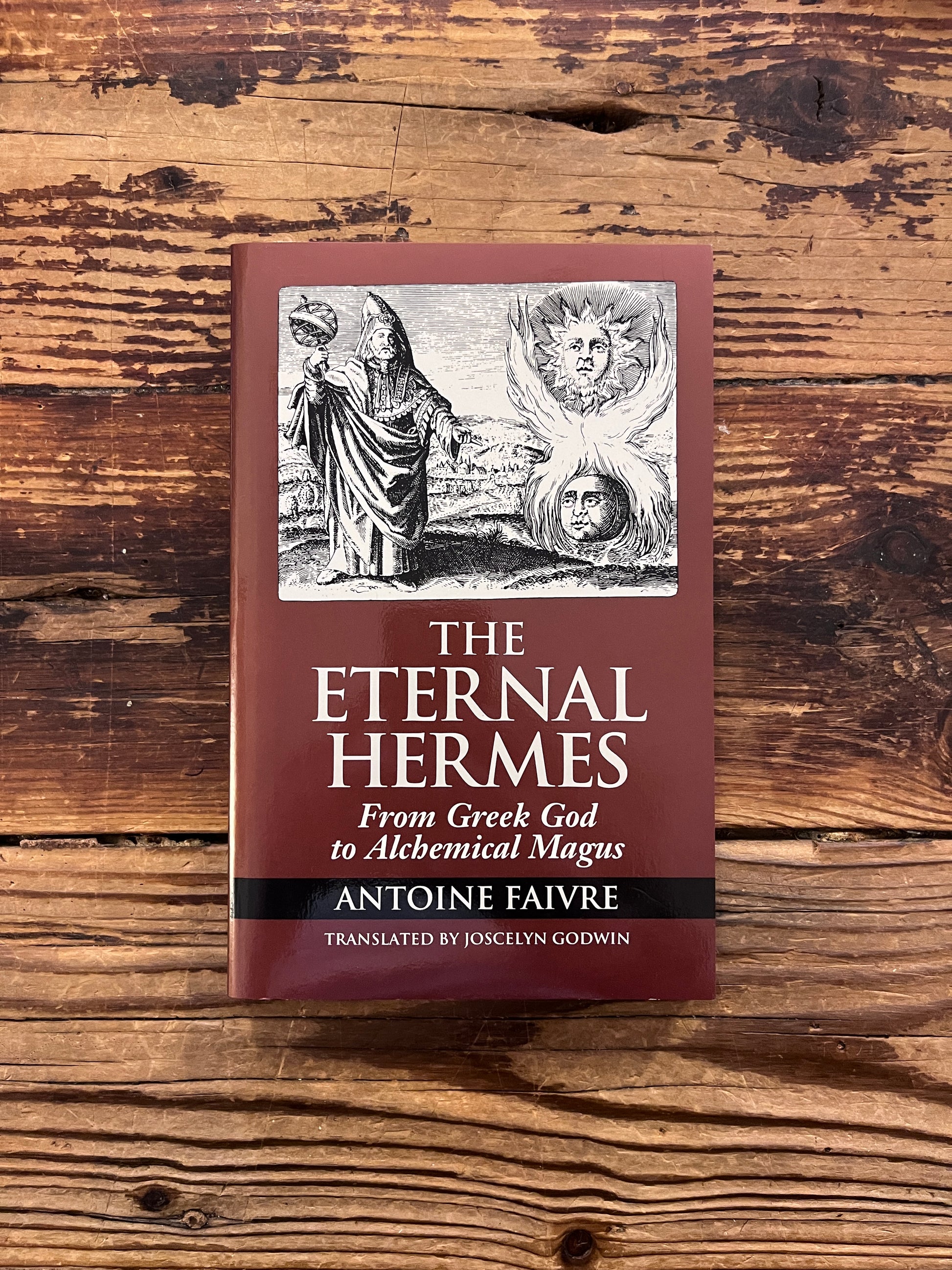 Front cover of the book titled 'the eternal Hermes' by Antoine Faivre on a wooden surface 