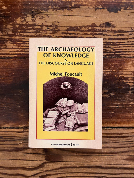 photo of the cover of the book "the archaeology of knowledge" on a wooden background