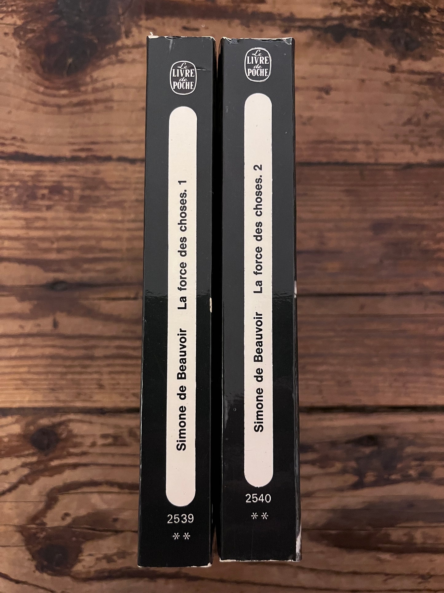 photo du dos des livres "la force des choses" sur fond de bois