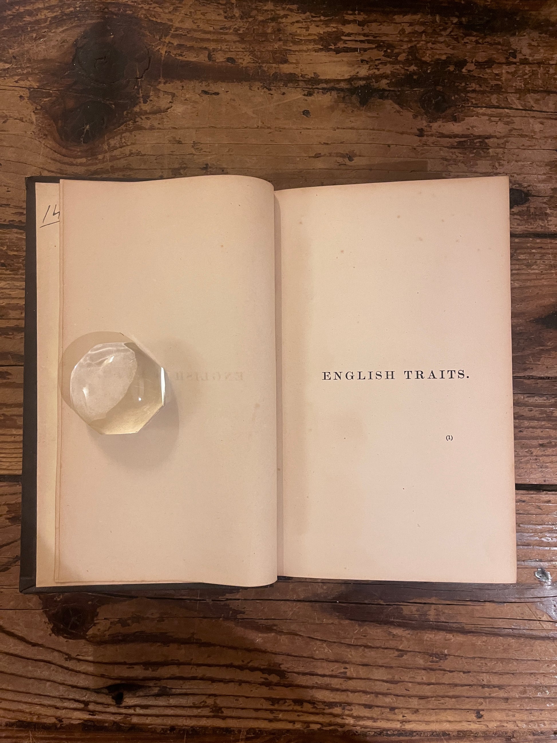 photo of the half title page of the book "english traits" on a wooden backgrounf