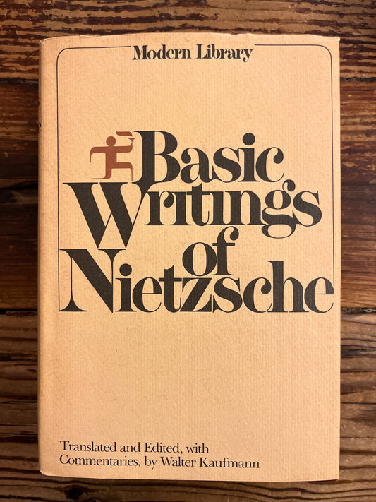 Book titled 'The Basic Writings of Nietzsche' on a wooden surface