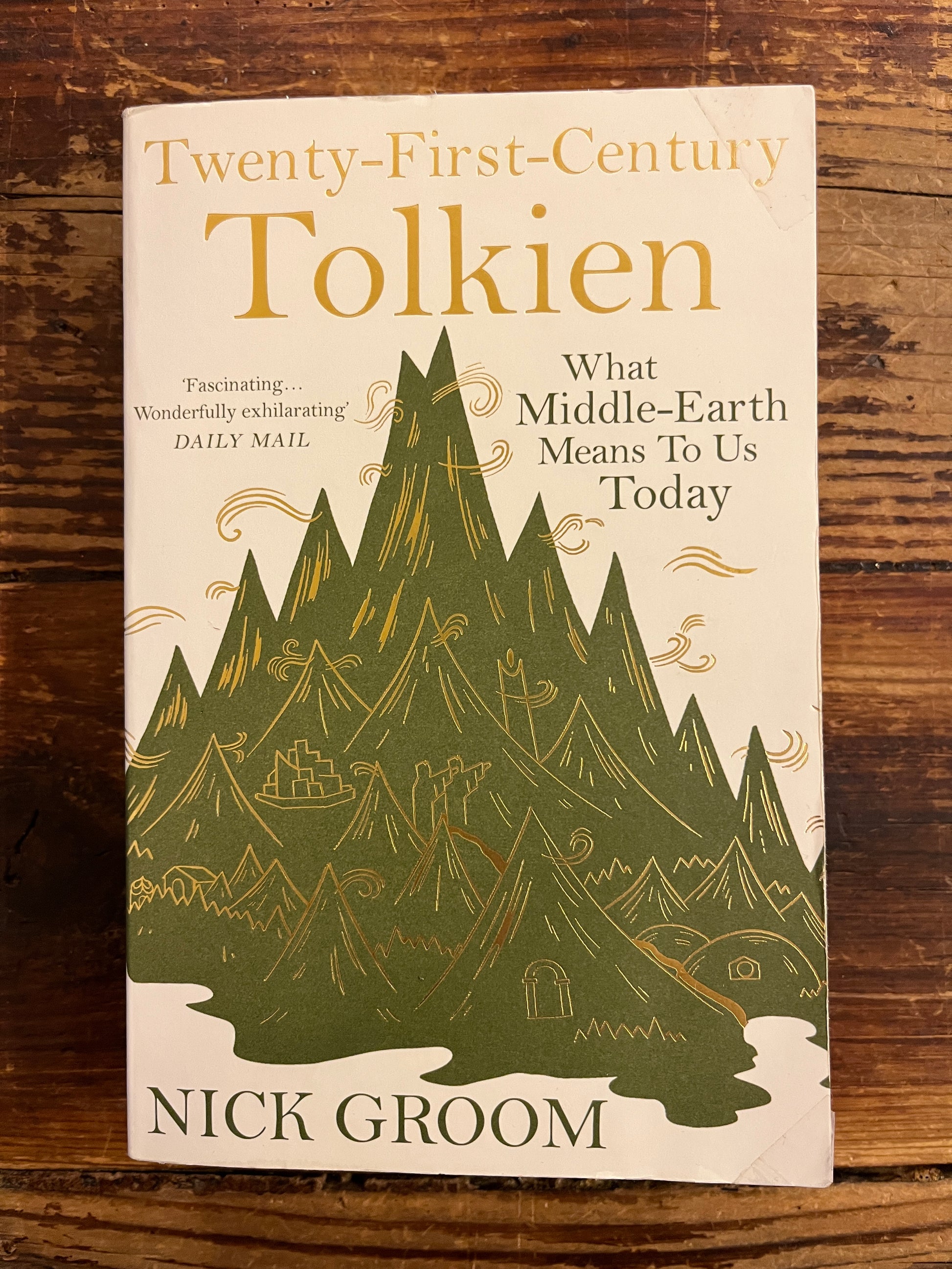 Book titled 'Twenty-First-Century Tolkien' by Nick Groom on a wooden surface