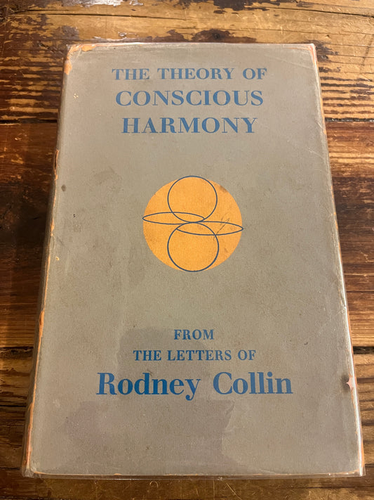 Book titled 'The Theory of Conscious Harmony' by Rodney Collin on a wooden surface