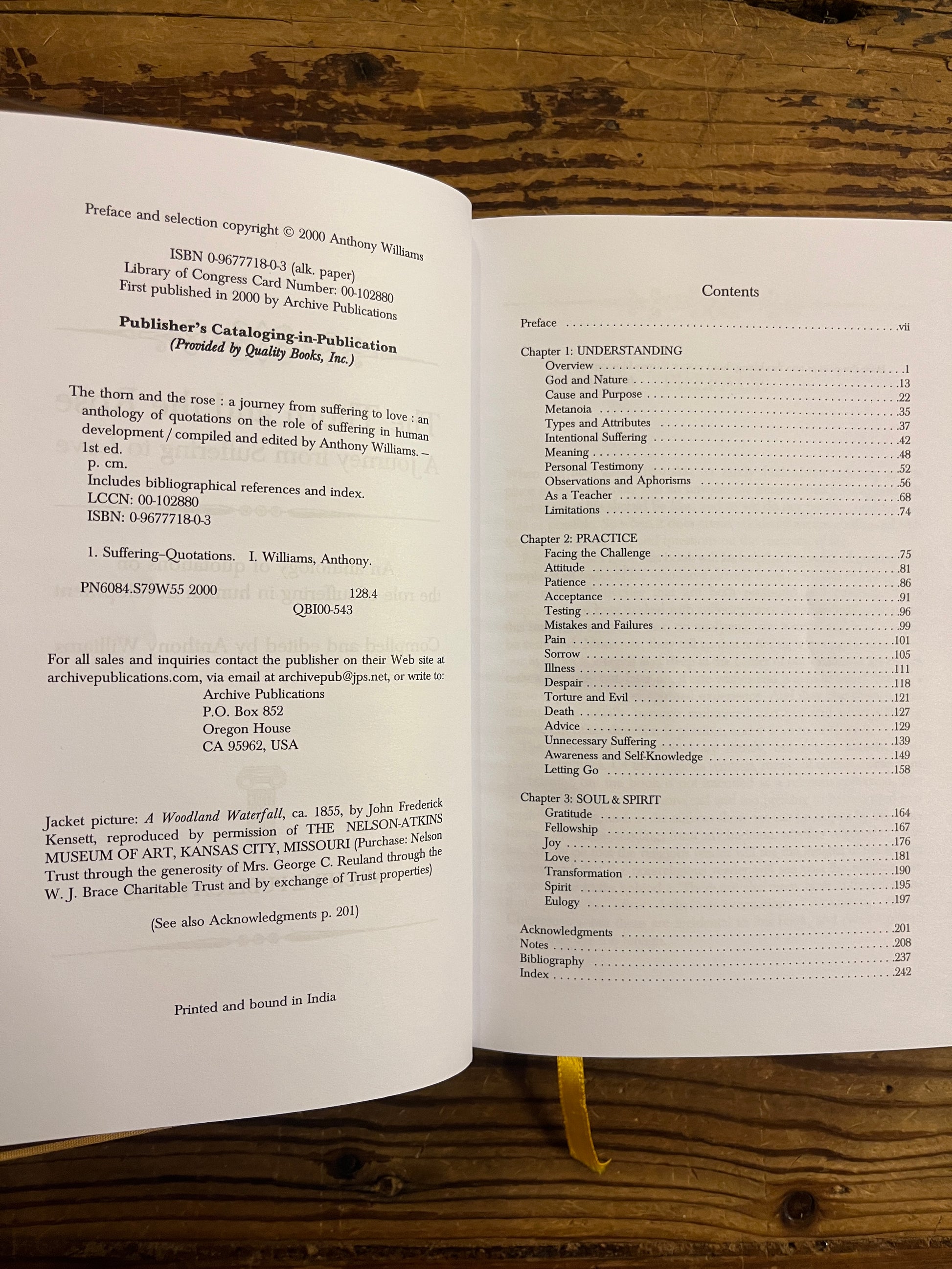 Open book titled 'The Thorn and the Rose' on a wooden surface