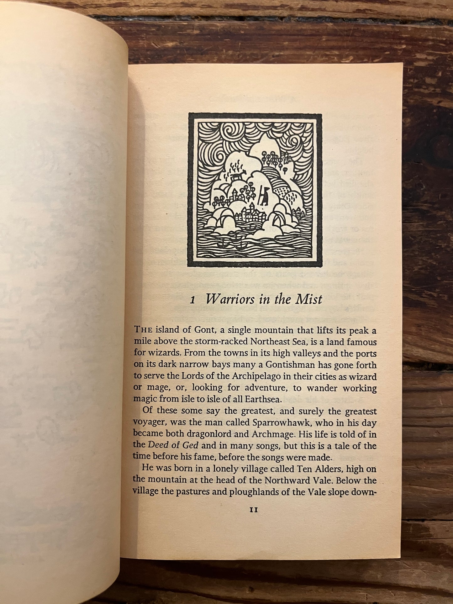 Open book 'a Wizard of Earthsea' by Ursula K. Le Guin on a wooden surface 