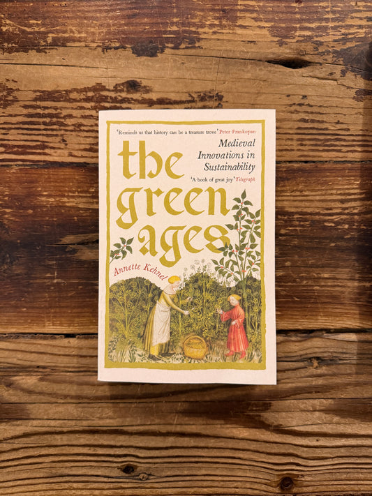 Front cover of the book 'The Green Ages' by Annette Kehnel on a wooden surface