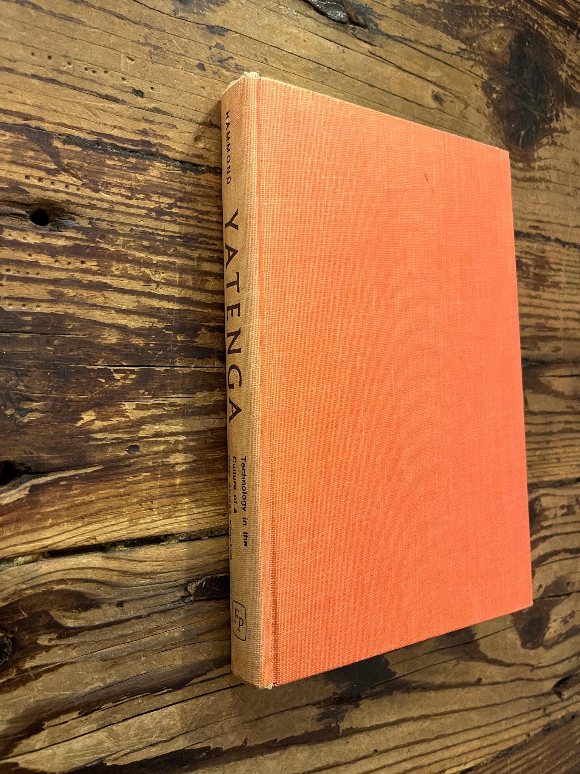 Spine and front cover of book titled 'Yatenga' by Peter B. Hammond on a wooden surface 