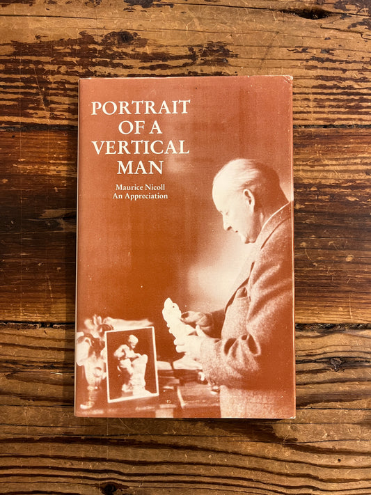 Book titled 'Portrait of a Vertical Man' on a wooden surface