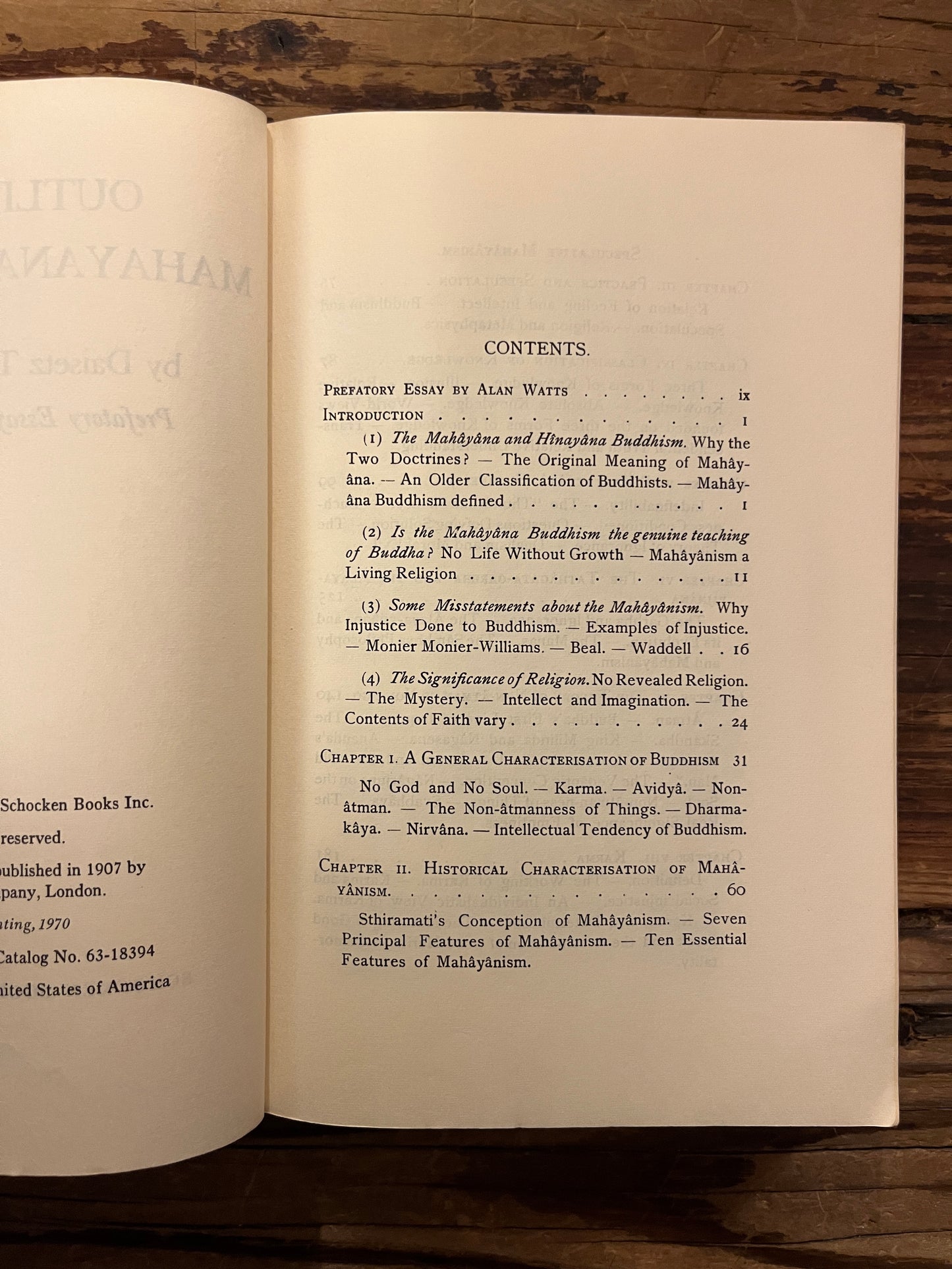 Open Book of 'Outlines of Mahayana Buddhism' by D.T. Suzuki on a wooden surface