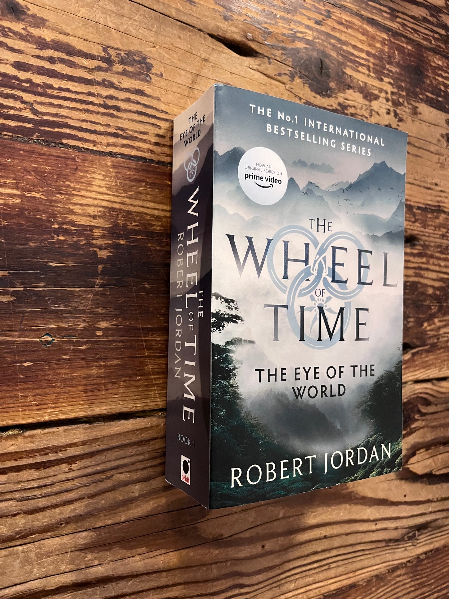 Book titled 'The Wheel of Time' by Robert Jordan on a wooden surface
