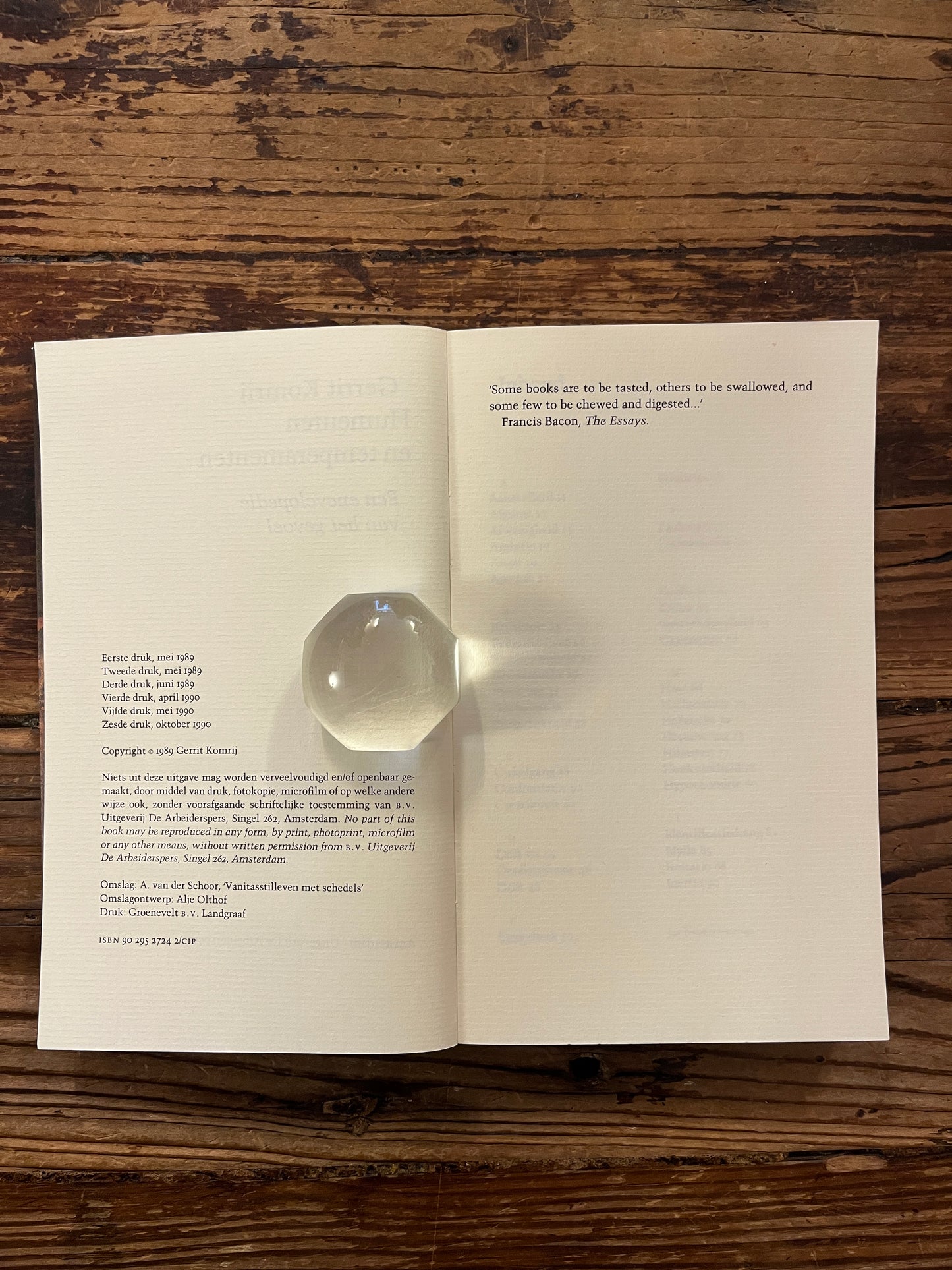 Open boek met de titel 'humeuren & temperamenten' door Gerrit Komrij op een houten achtergrond 