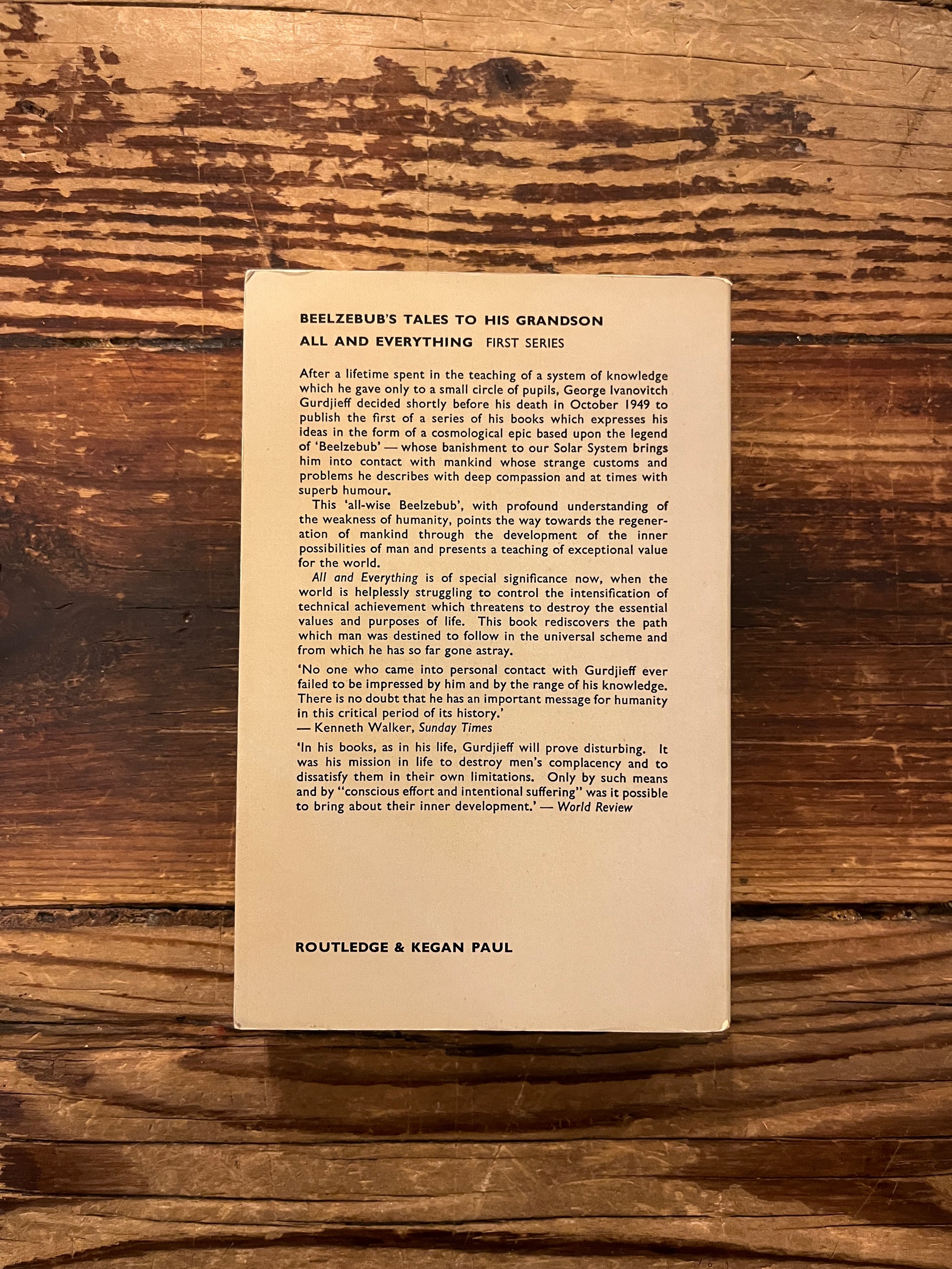 Backcover of 'beelzebub's tales to his grandson by Gurdjieff on a wooden surface
