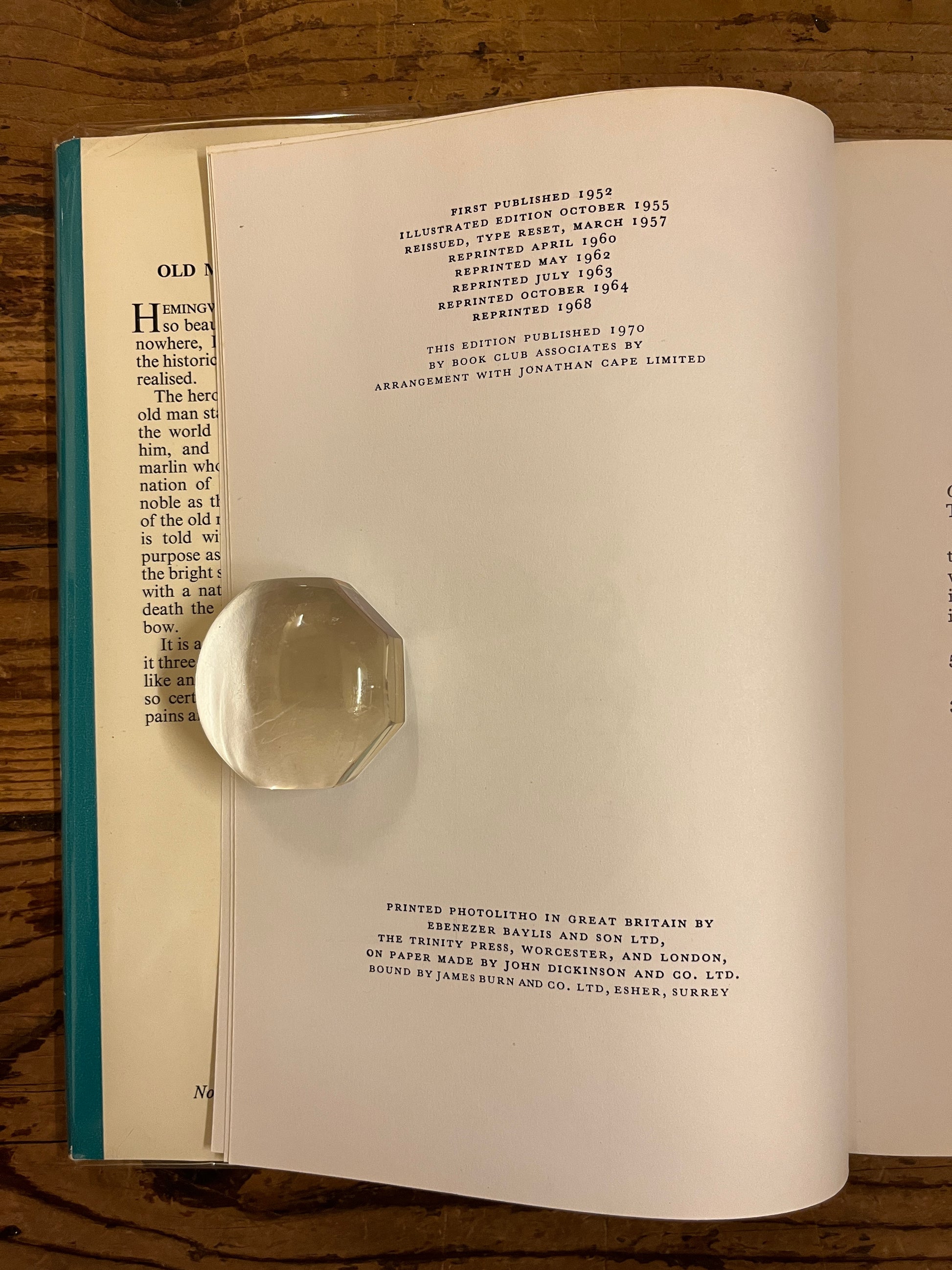 photo of the edition page of the book "the old man and the sea" on a wooden background