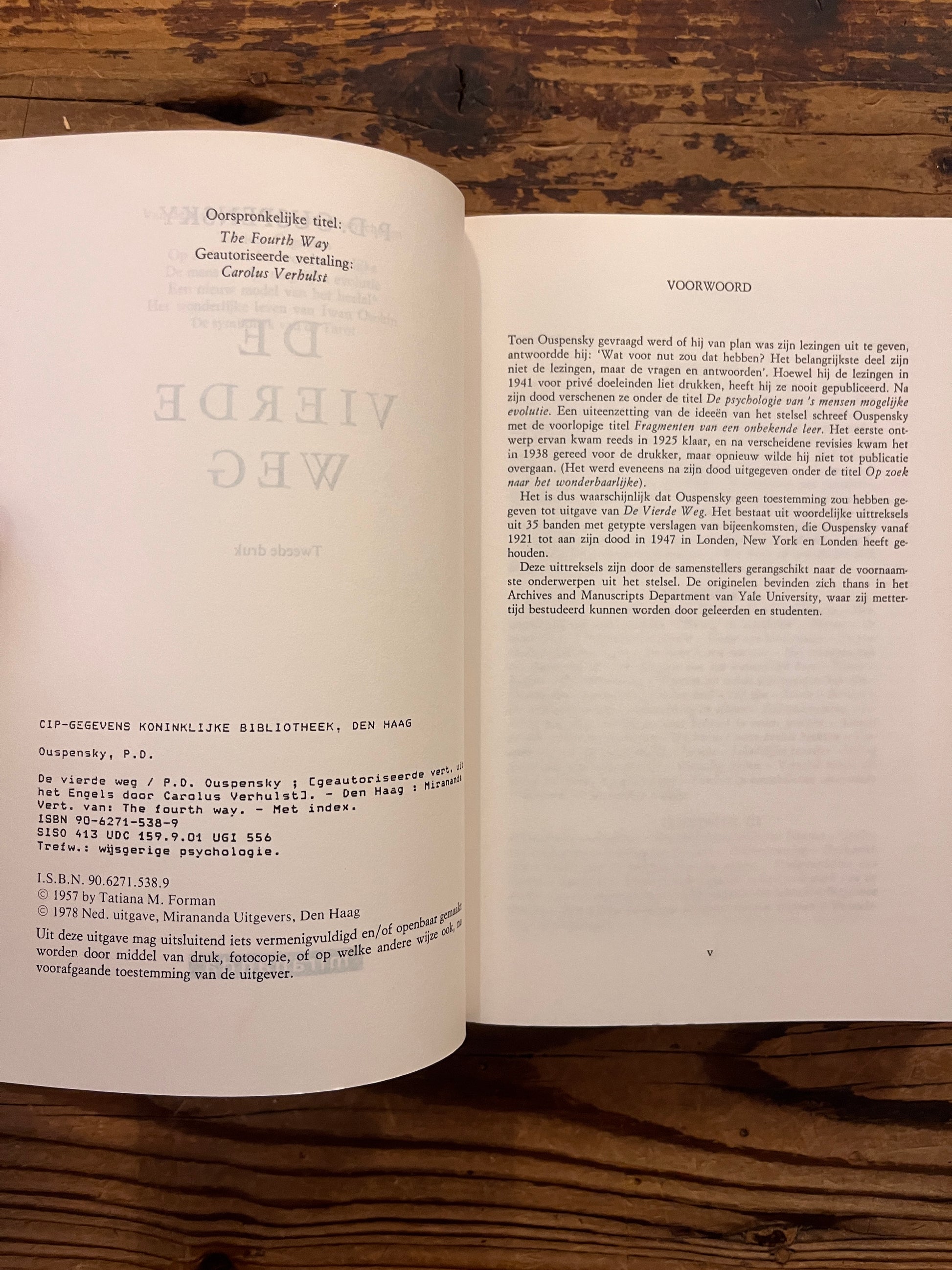 Open boek met de titel 'de vierde weg door P.D. Ouspensky op een houten achtergrond 