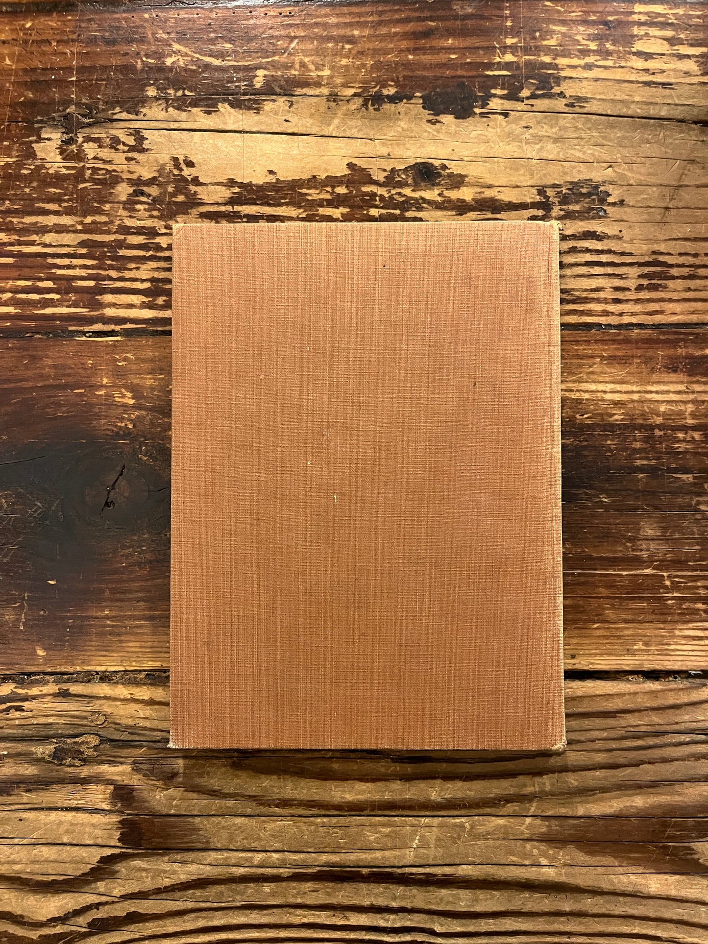 Back cover of book titled 'The Purpose of Life'  by Inayat Khan on a wooden surface