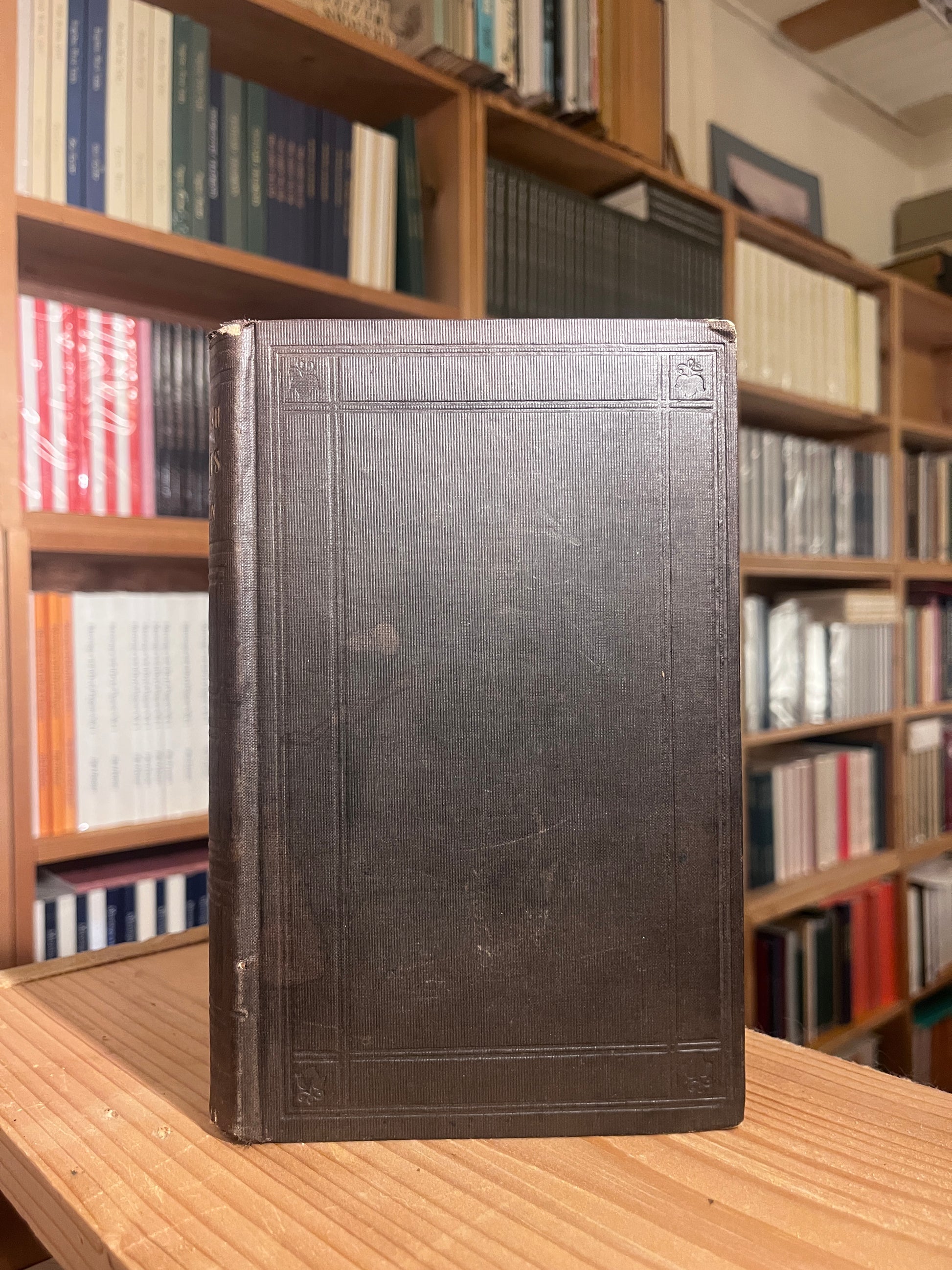 photo of the cover of hte book "english traits" with book shelves in the background