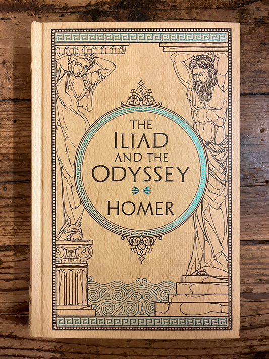 photo of the cover of the book "the iliad and the odyssey" on a wooden background
