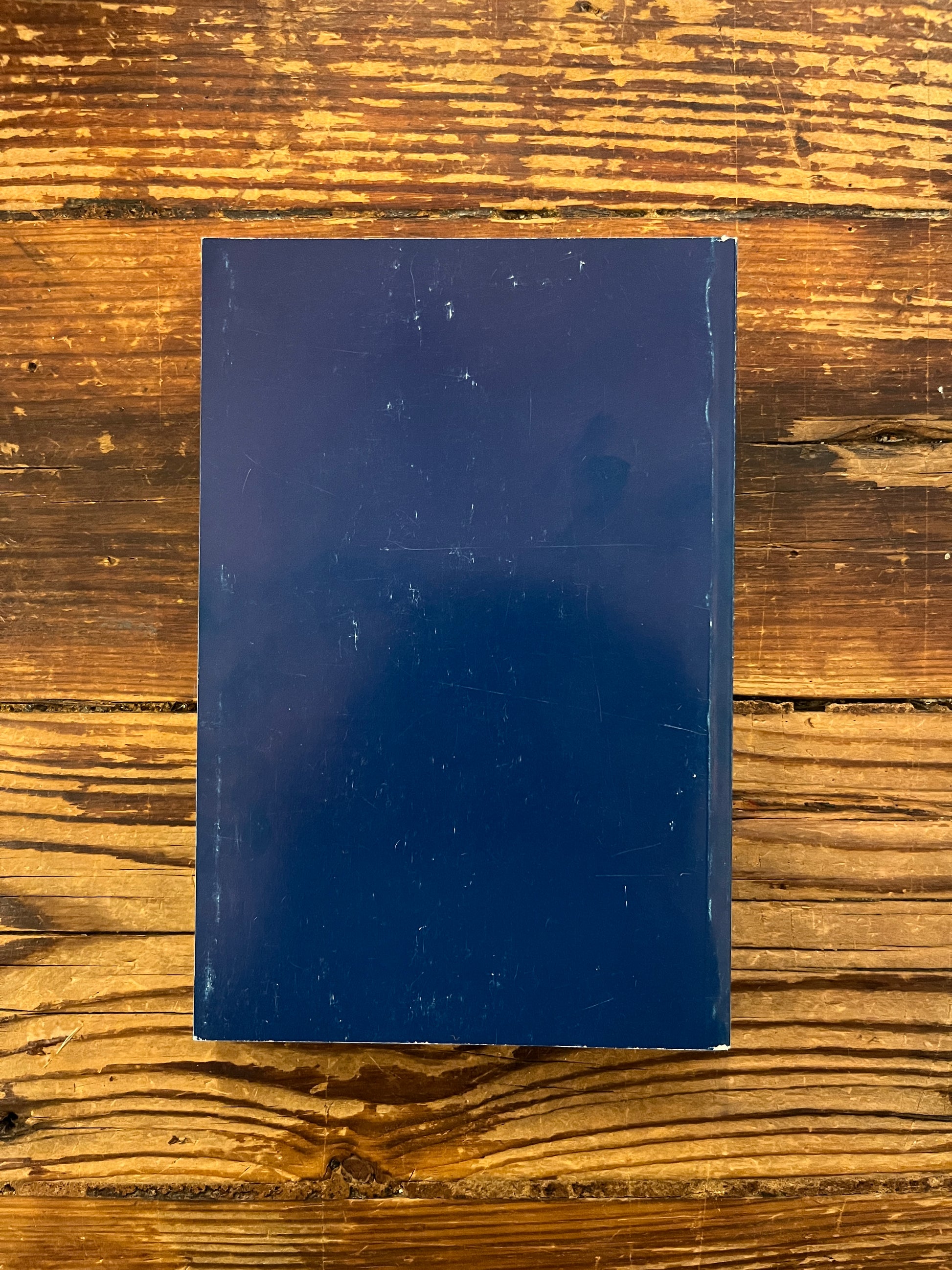 Back cover of book titled 'The Bridge n.12 P.D. Ouspensky  commemorative issue' on a wooden surface