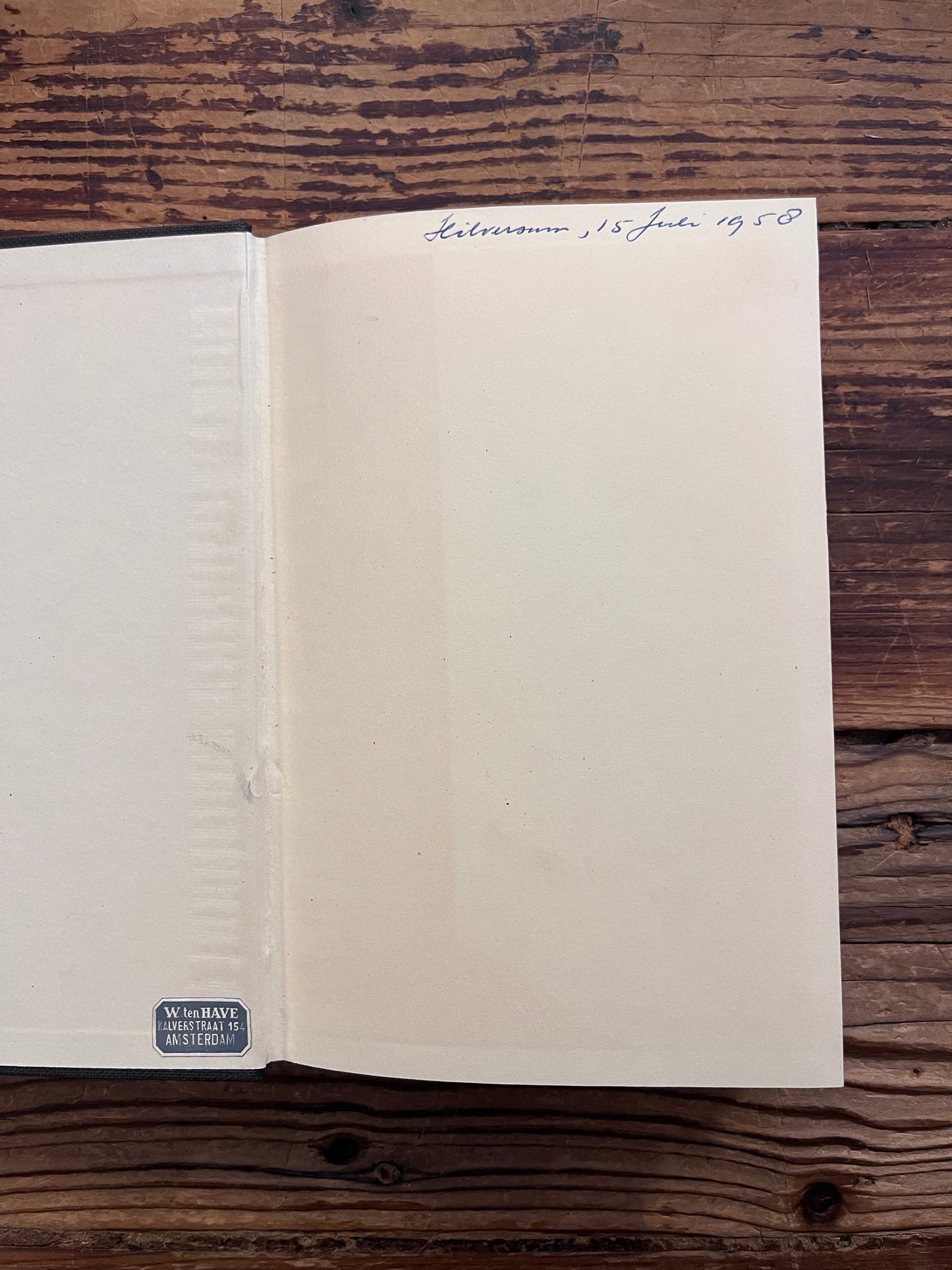 Open book titled 'The Road Waits' by Peter Lanham on a wooden surface