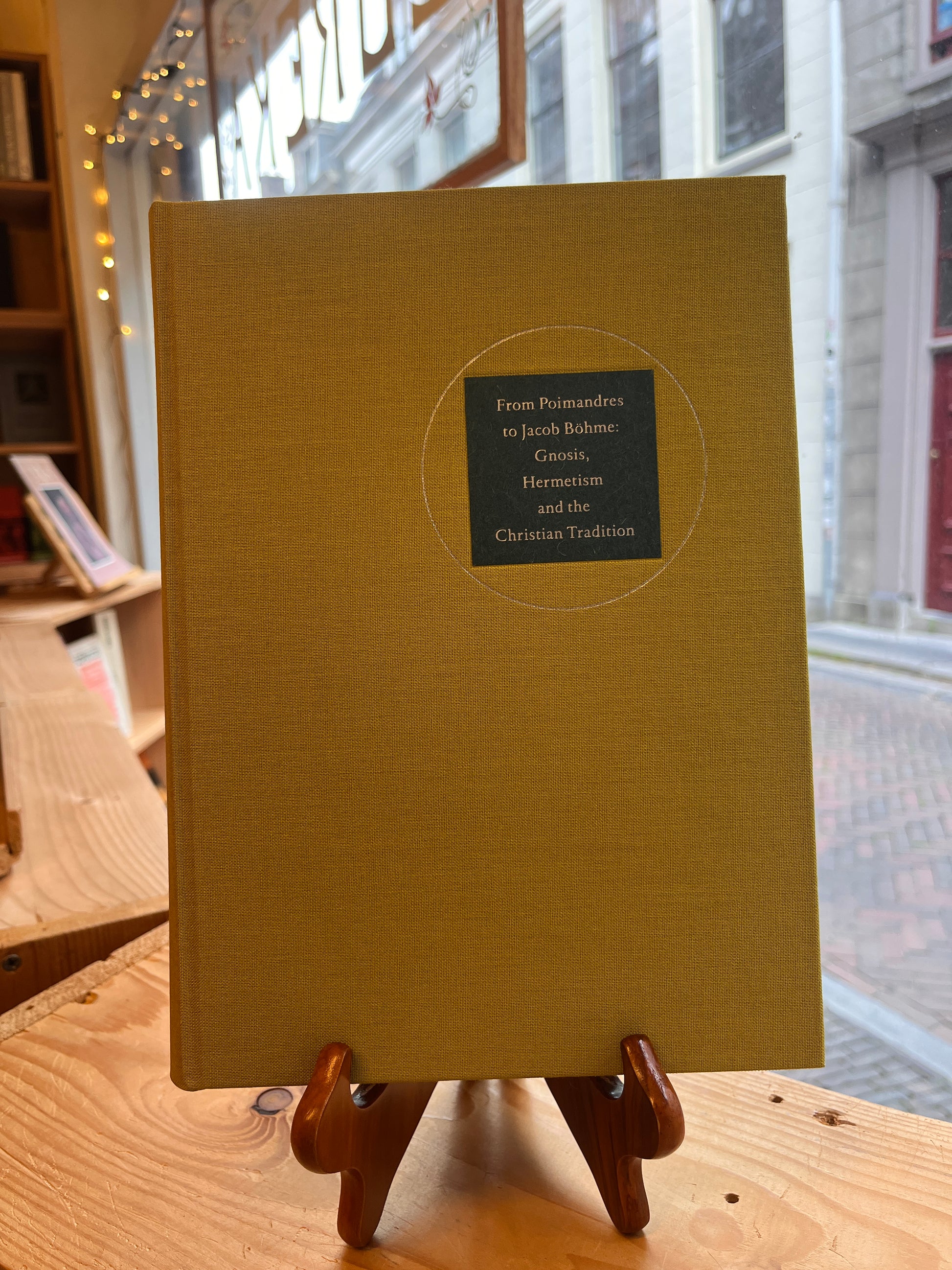 Front cover of book titled 'From Poimandres to Jacob Böhme: Gnosis, Hermetism, and the Christian tradition Edited by Roelof van den Broek and Cis van Heertum' in front of  window