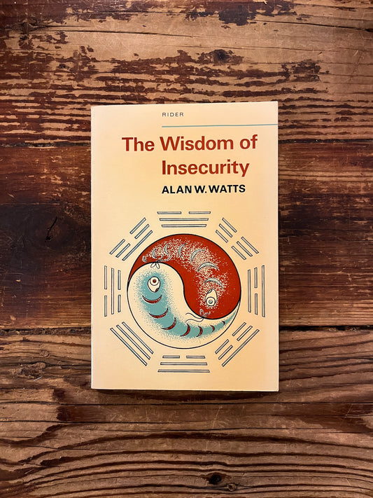 Book cover of 'The Wisdom of Insecurity' by Alan W. Watts on a wooden surface