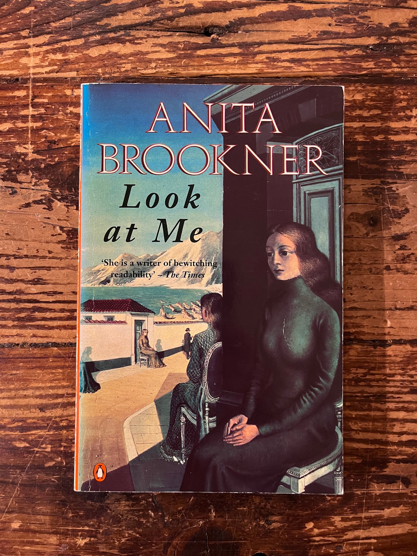 Photo of the cover of the book " look at me" on a wooden background