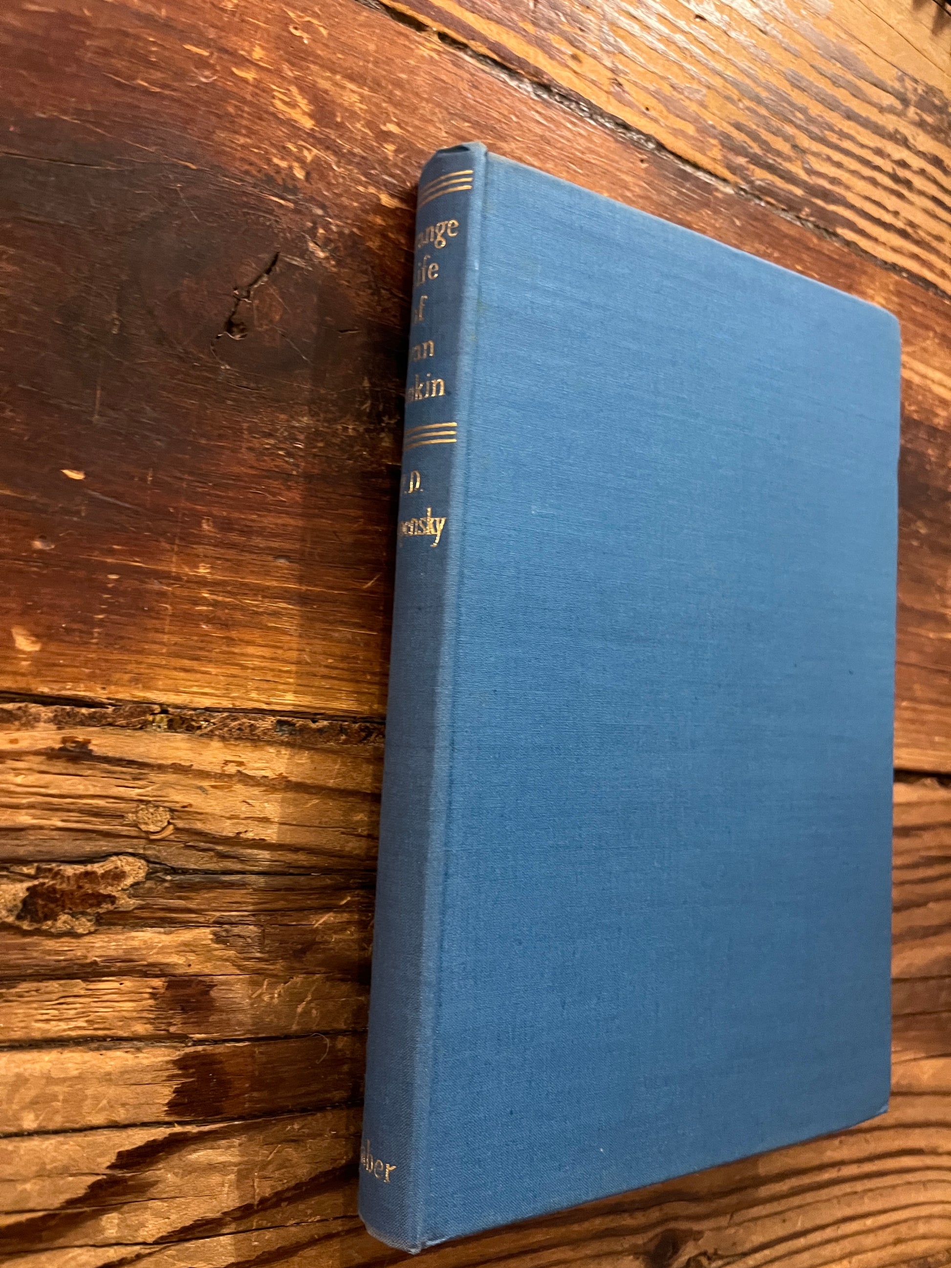 Book titled 'Strange Life of Ivan Osokin' by P.D. Ouspensky on a wooden surface