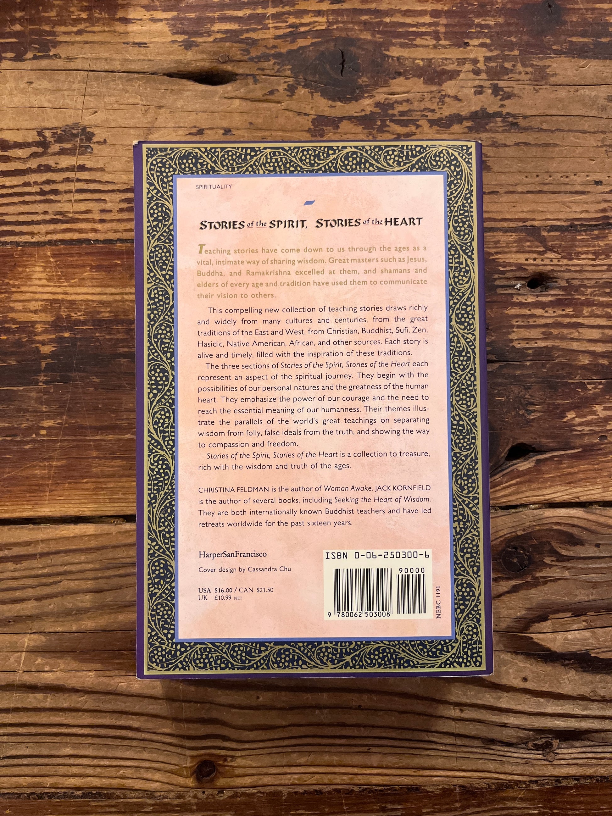 Book titled 'Stories of the Spirit, Stories of the Heart' on a wooden surface