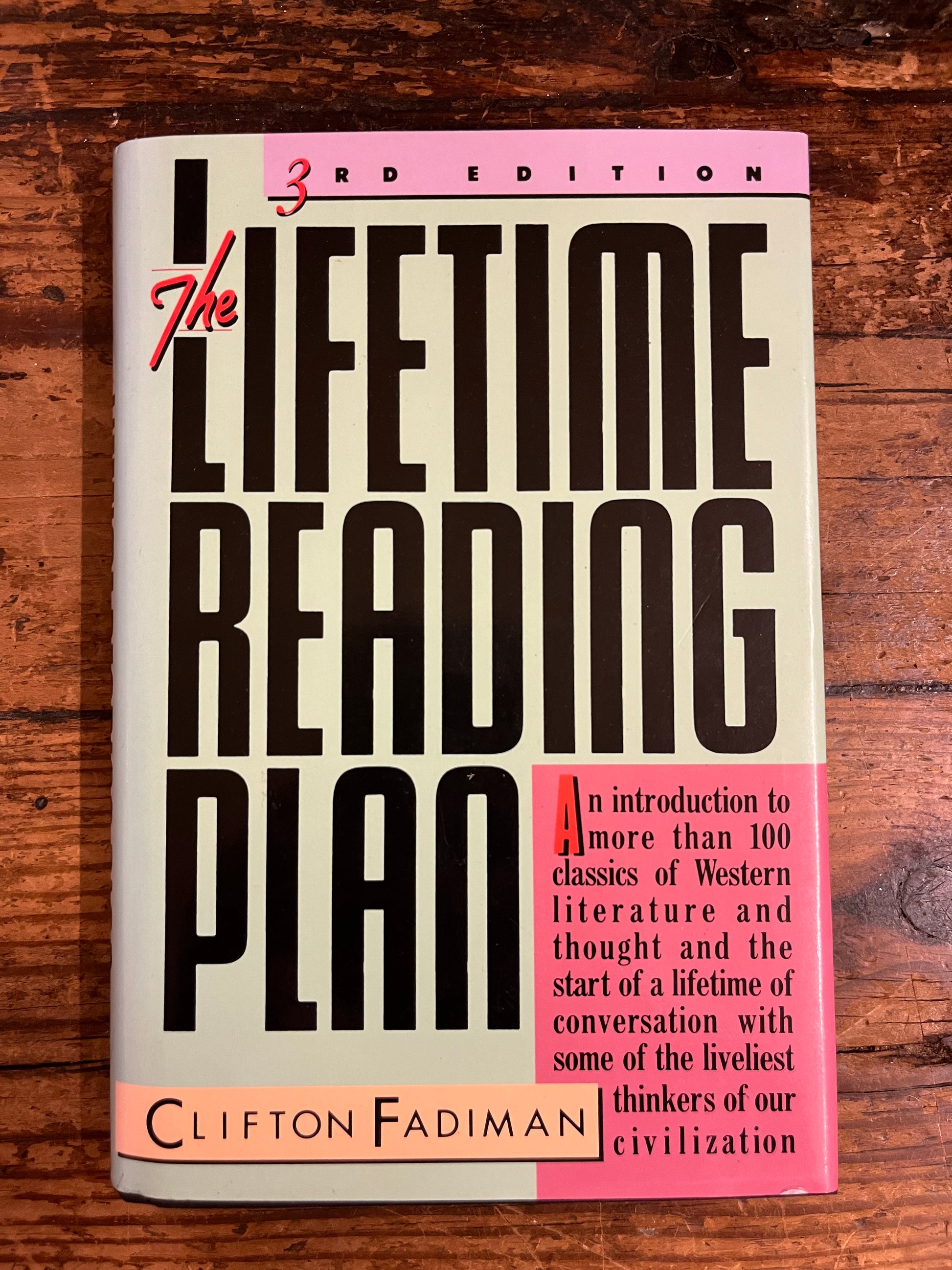 cover of the book "The lifetime reading plan" on a wooden background