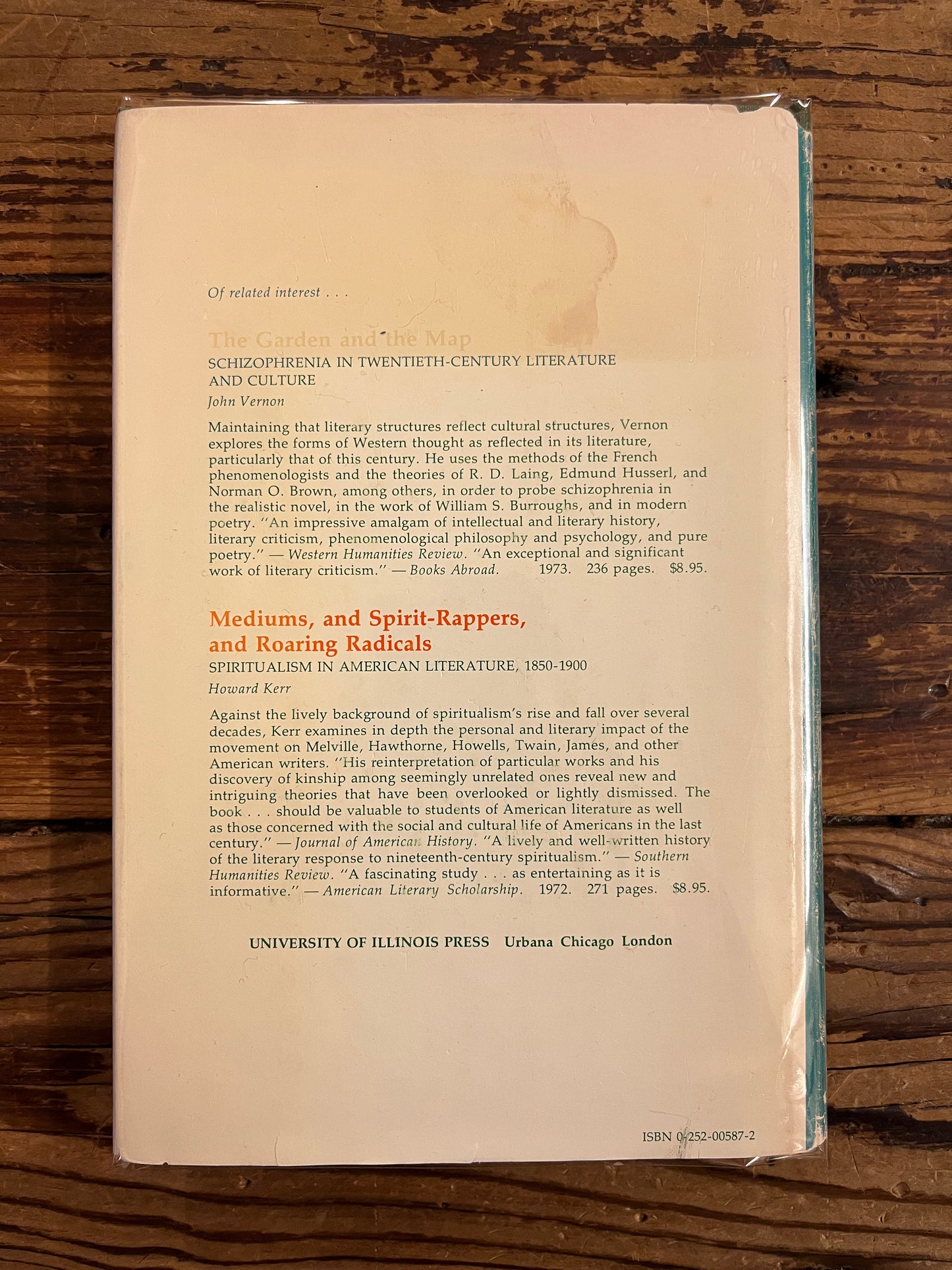 Backcover of a book titled 'The Game of the Impossible: A Rhetoric of Fantasy' by W.R. Irwin on a wooden surface