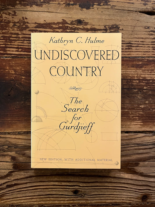 Book titled 'Undiscovered Country: The Search for Gurdjieff' by Kathryn Hulme on a wooden surface