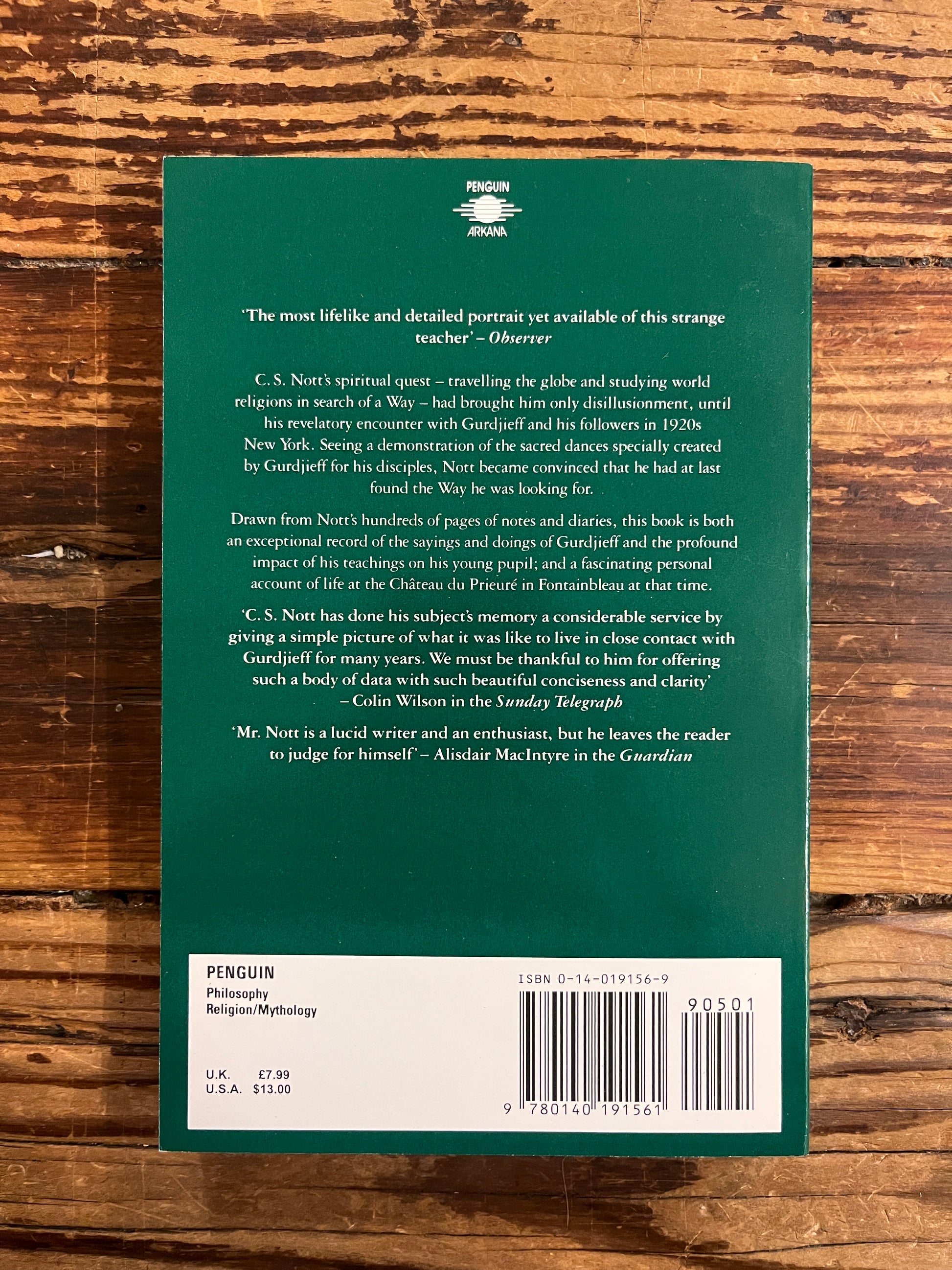 Back cover book titled 'Teachings of Gurdjieff: A Pupil's Journal' by C.S. Nott on a wooden surface