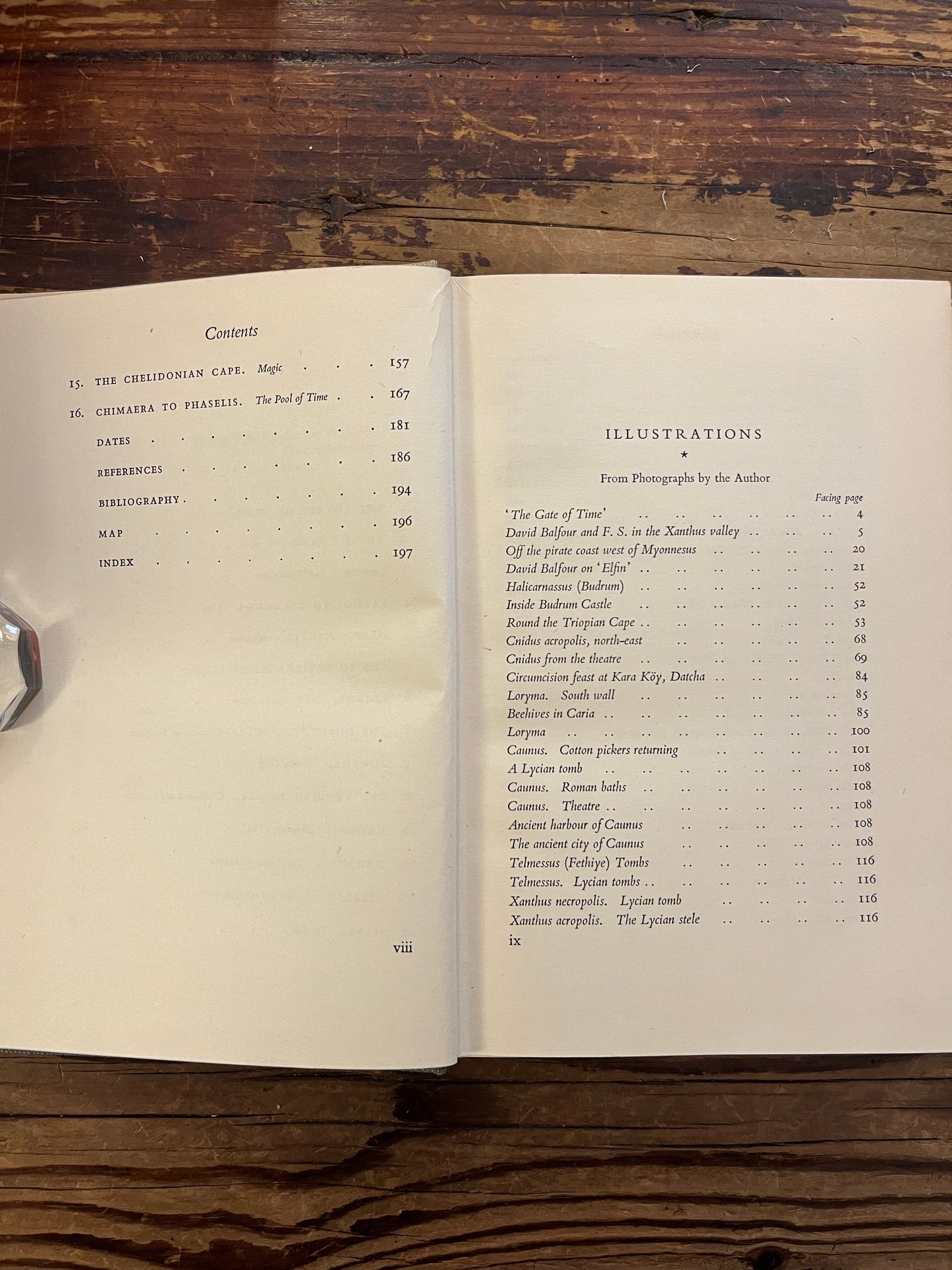 Open book showing the contents of book titled 'The Lycian Shore' by Freya Stark on a wooden surface