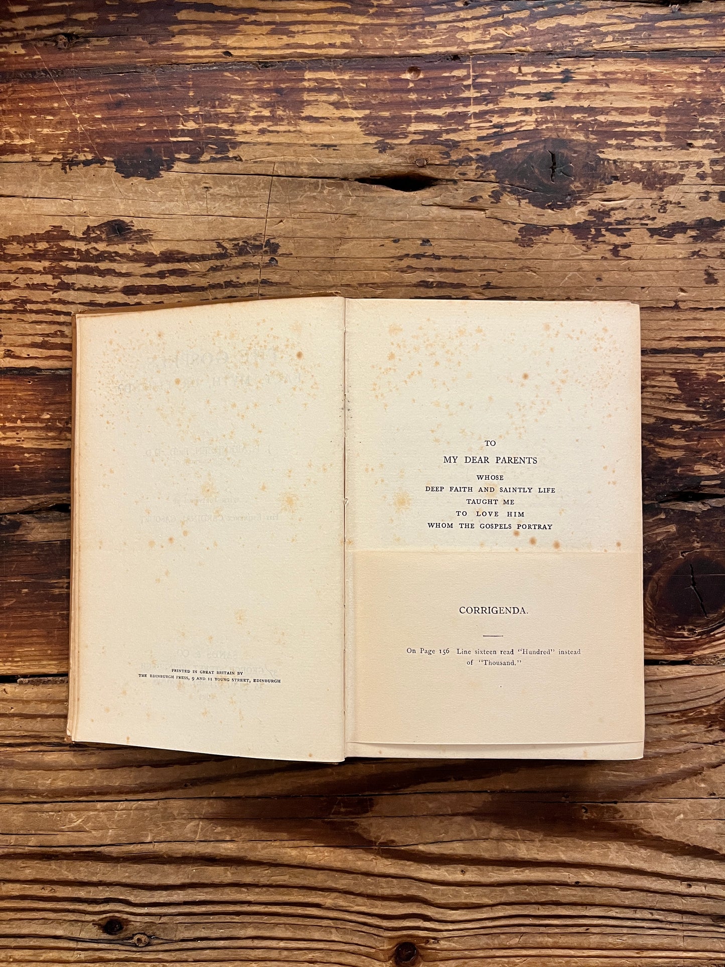 Open book with the title 'the gospels, fact, myth or legend ? by J.P. Arendzen Ph.D. on a wooden surface