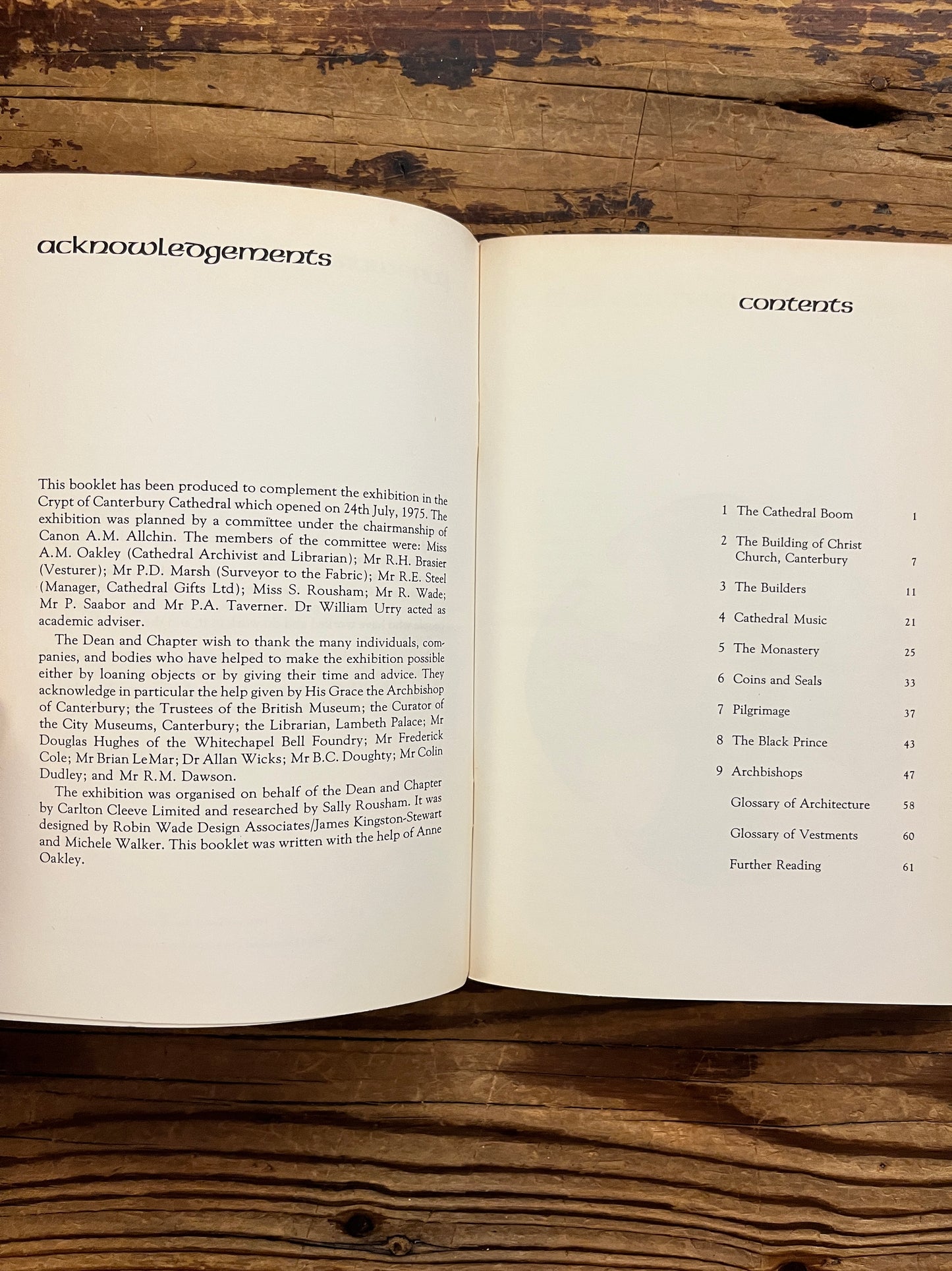 Open book titled 'Canterbury: the story of a cathedral' showing the contents, lying on a wooden surface
