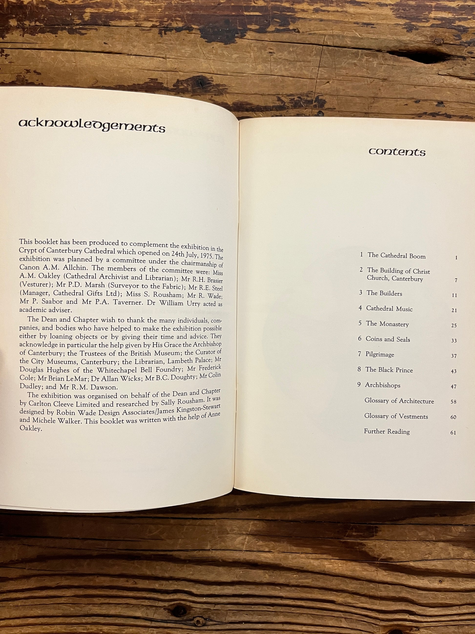 Open book titled 'Canterbury: the story of a cathedral' showing the contents, lying on a wooden surface