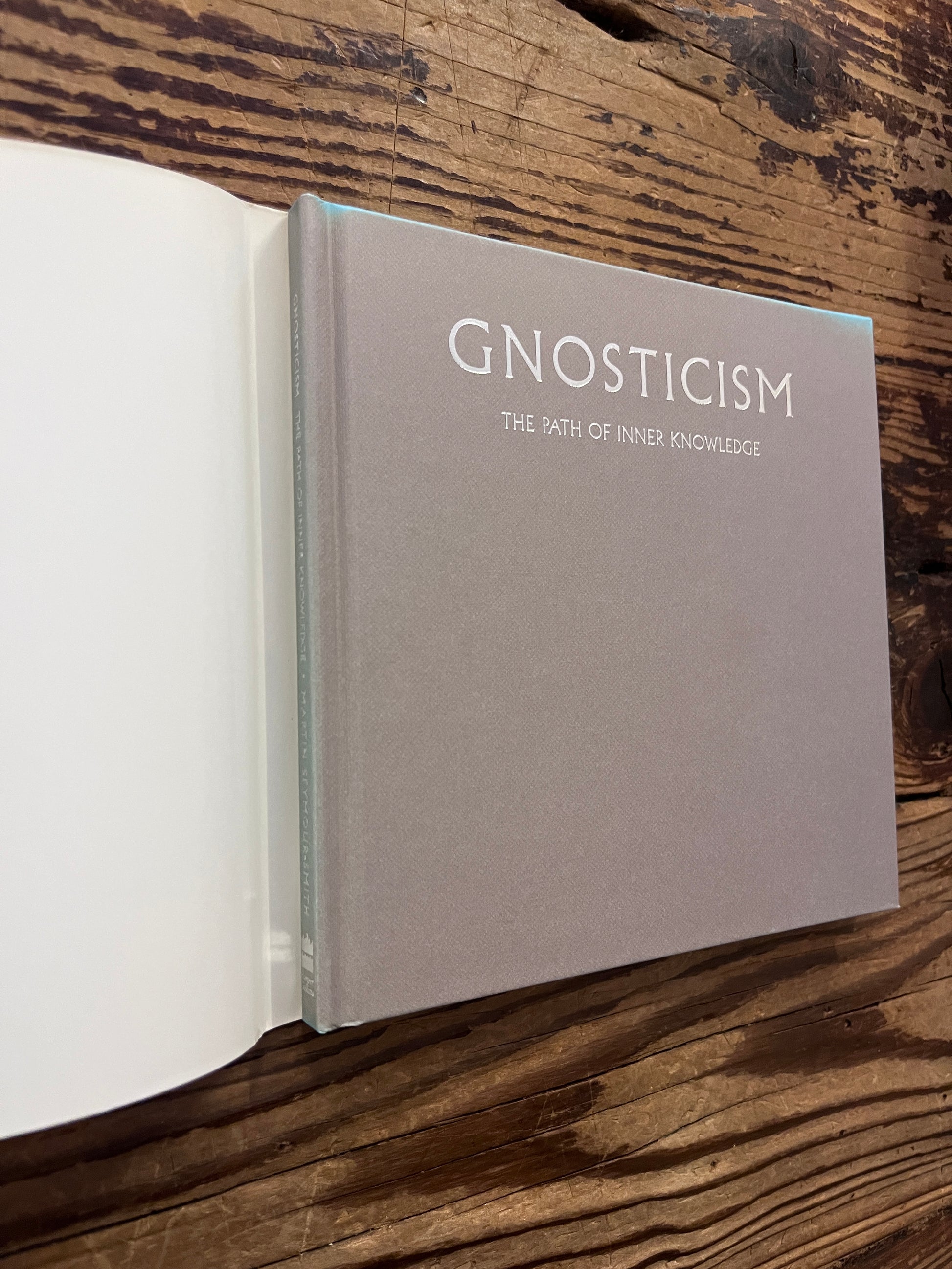 Front cover of a book without dust-jacket titled 'Gnosticism: The Path of Inner Knowledge' by Martin Seymour-Smith on a wooden surface 
