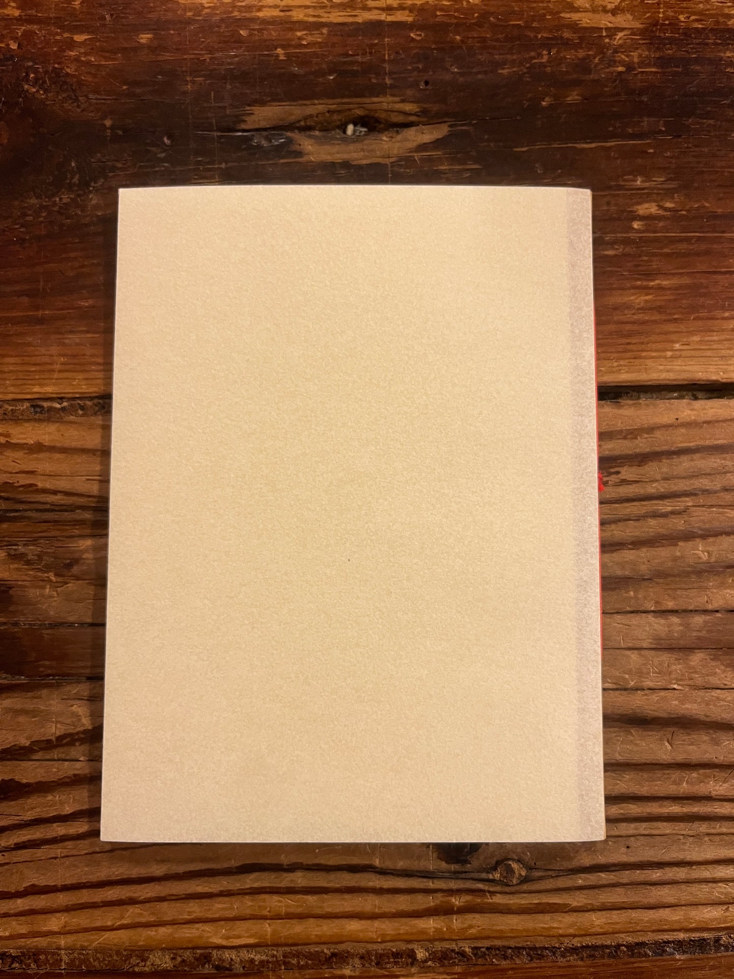 back side of book titled 'Poems of Sacrifice' by P.D. Ouspensky on a wooden surface