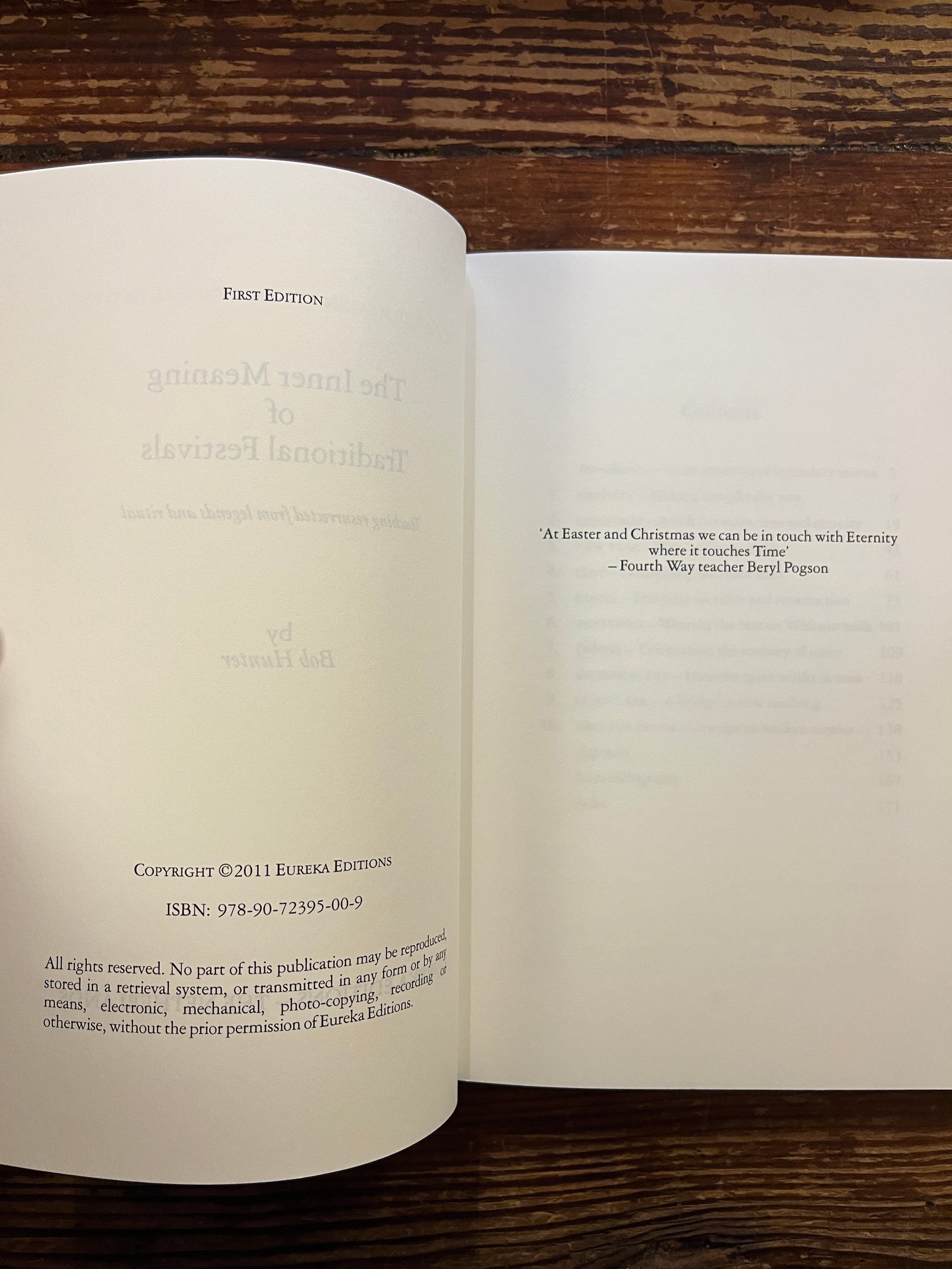 Open book titled 'The Inner Meaning of Traditional Festivals' by Bob Hunter on a wooden surface