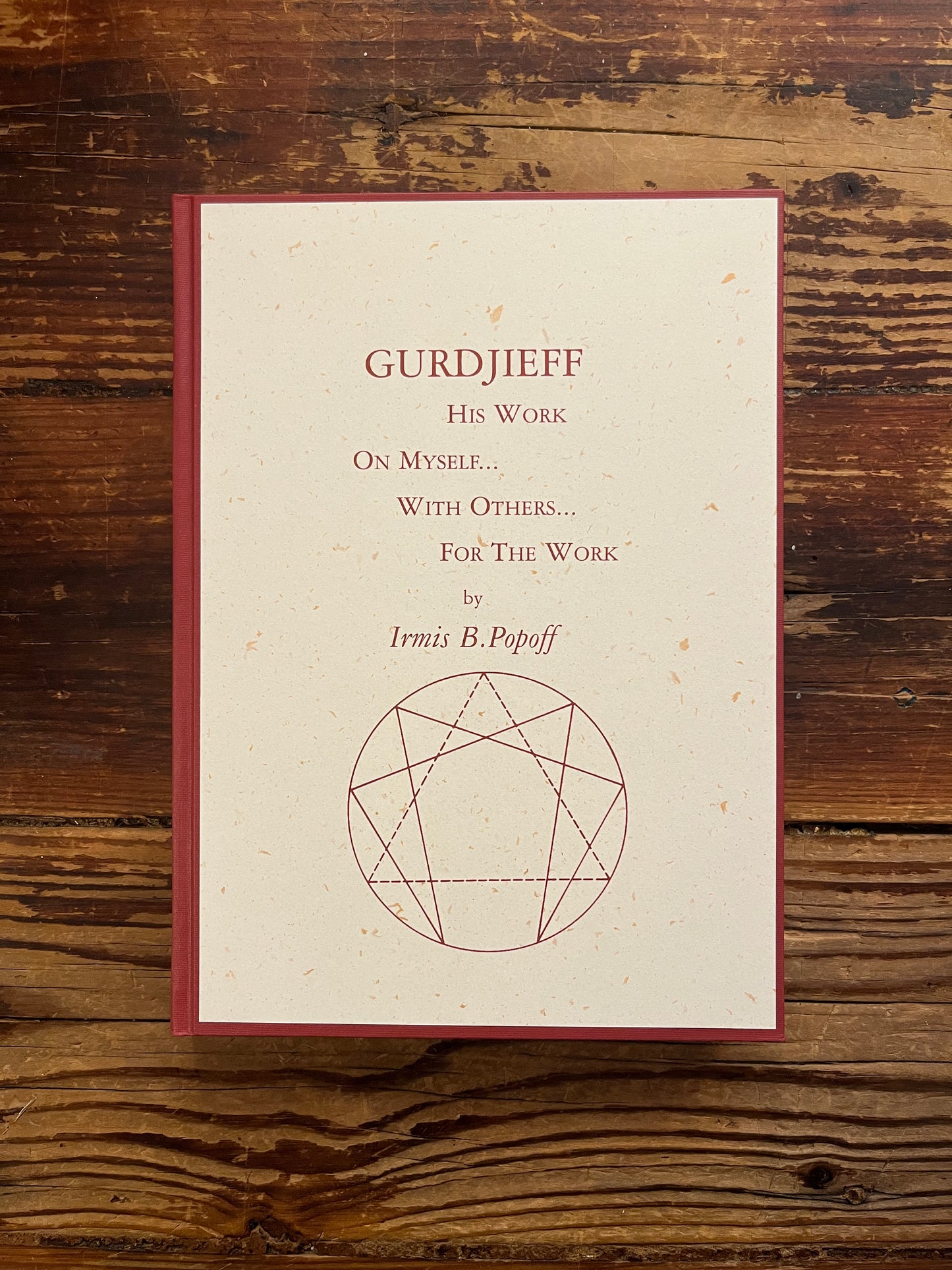 Front cover of book with the title 'Gurdjieff, His work, on myself, with others, for the work' by Irmis B. Popoff on a wooden surface 