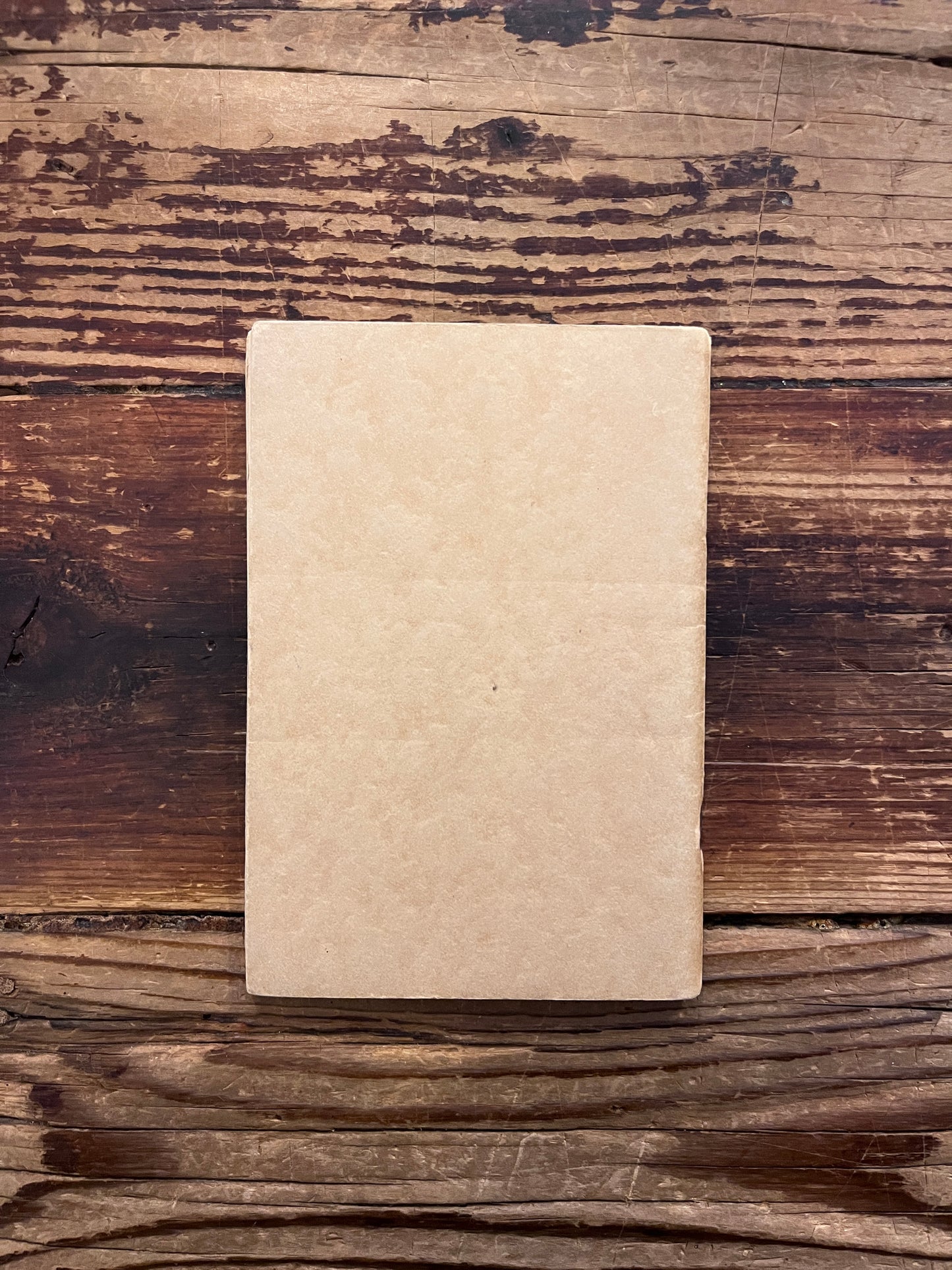 Back cover of booklet titled 'KFI radio talks on philosophy and psychology' by Manly P. Hall on a wooden surface